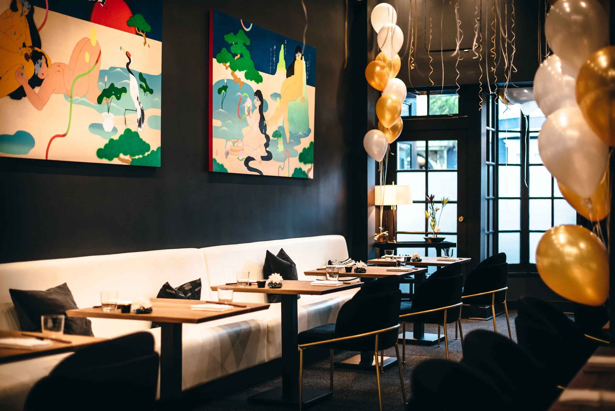 Nisei dining room set for service—warm lighting and refined atmosphere