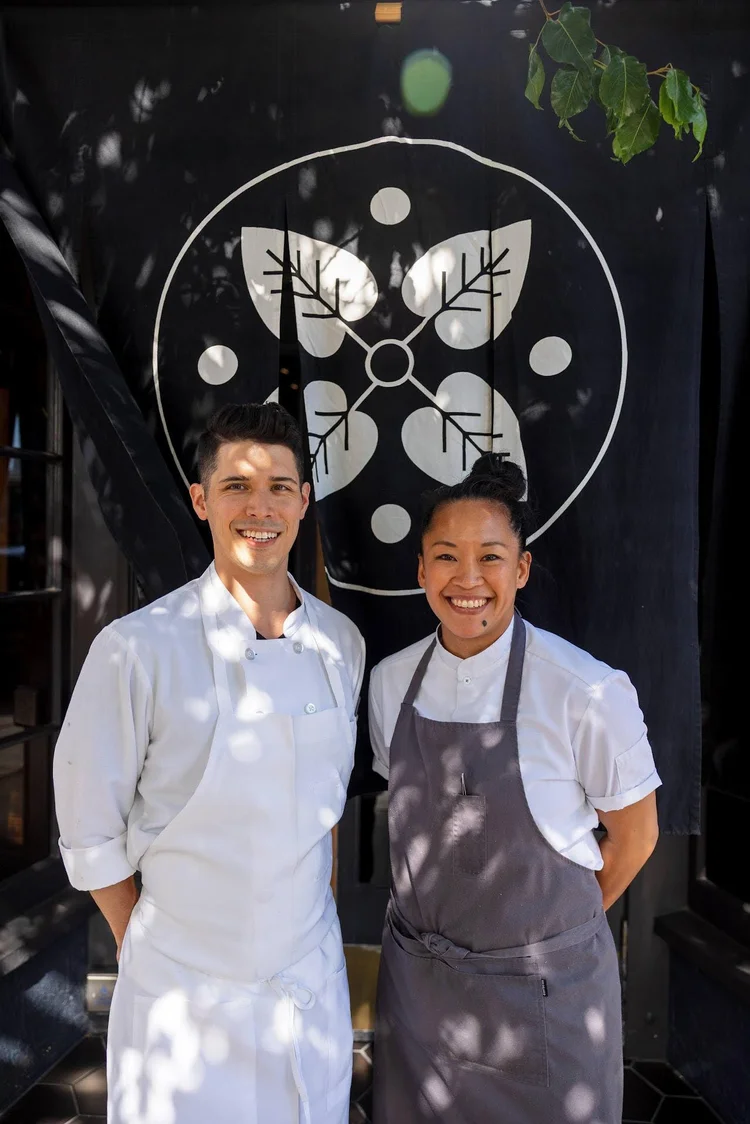 Nisei collaboration dinner scene with chefs and guests in warm light