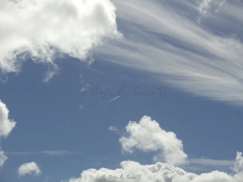 View 320 - distant jet flying through various white clouds in blue sky, Wildlife, California USA, Fall 2014