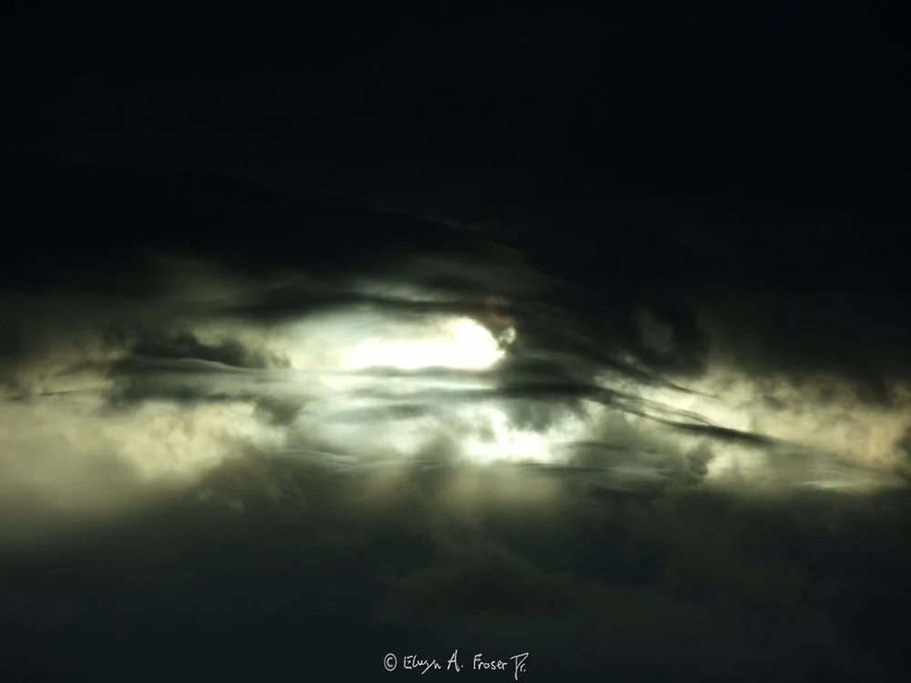 View 403 - sun beaming through opening in thick silhouetted clouds, Abstract, Wildlife, Minnesota USA, Spring 2015