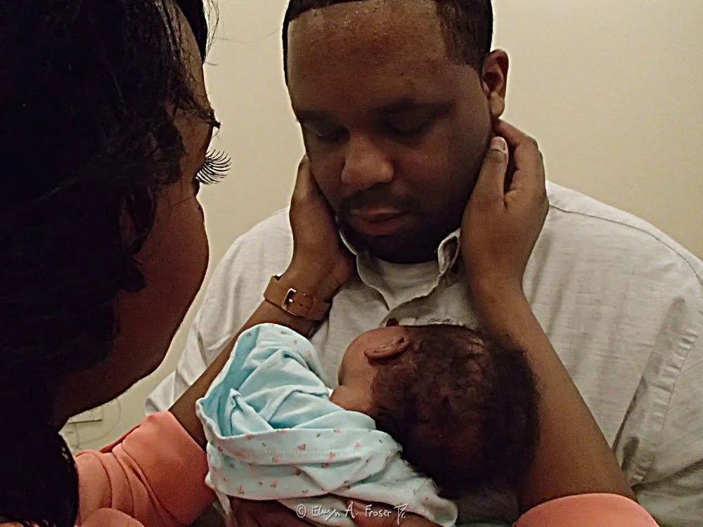 View 486 - young African American family reverently embracing each other, Humanity, Wilder Foundation Minnesota USA, Winter 2015/2016