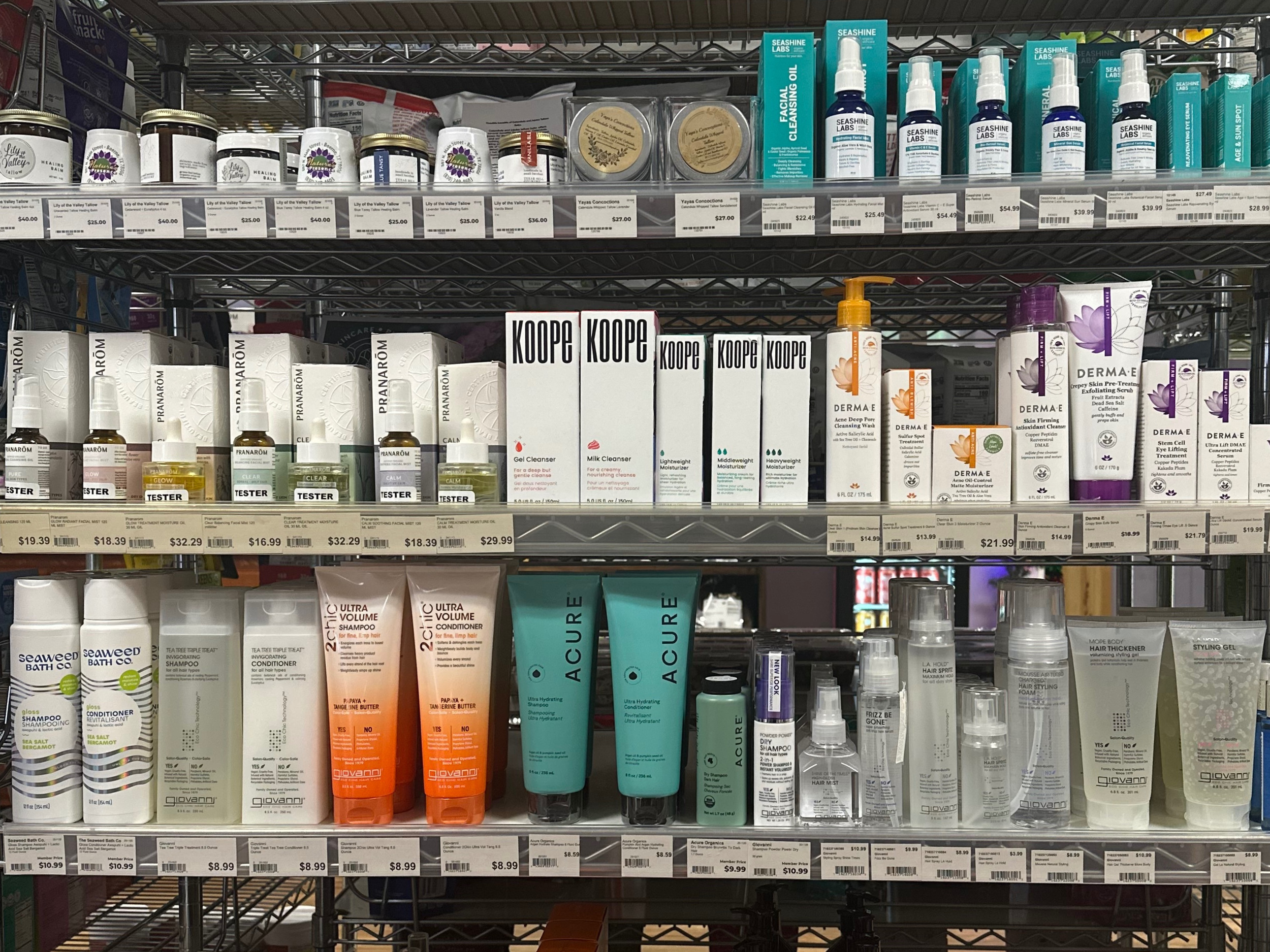 Creams in pink, purple, white, and green colors spread on a flat surface.