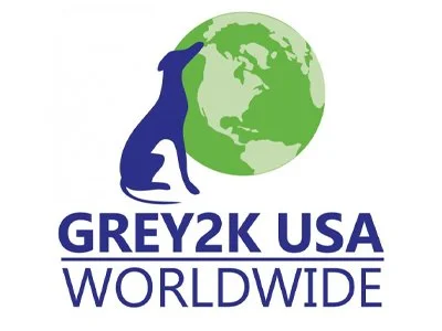 A silhouette of a greyhound next to a green earth with the text GREY2K USA WORLDWIDE.