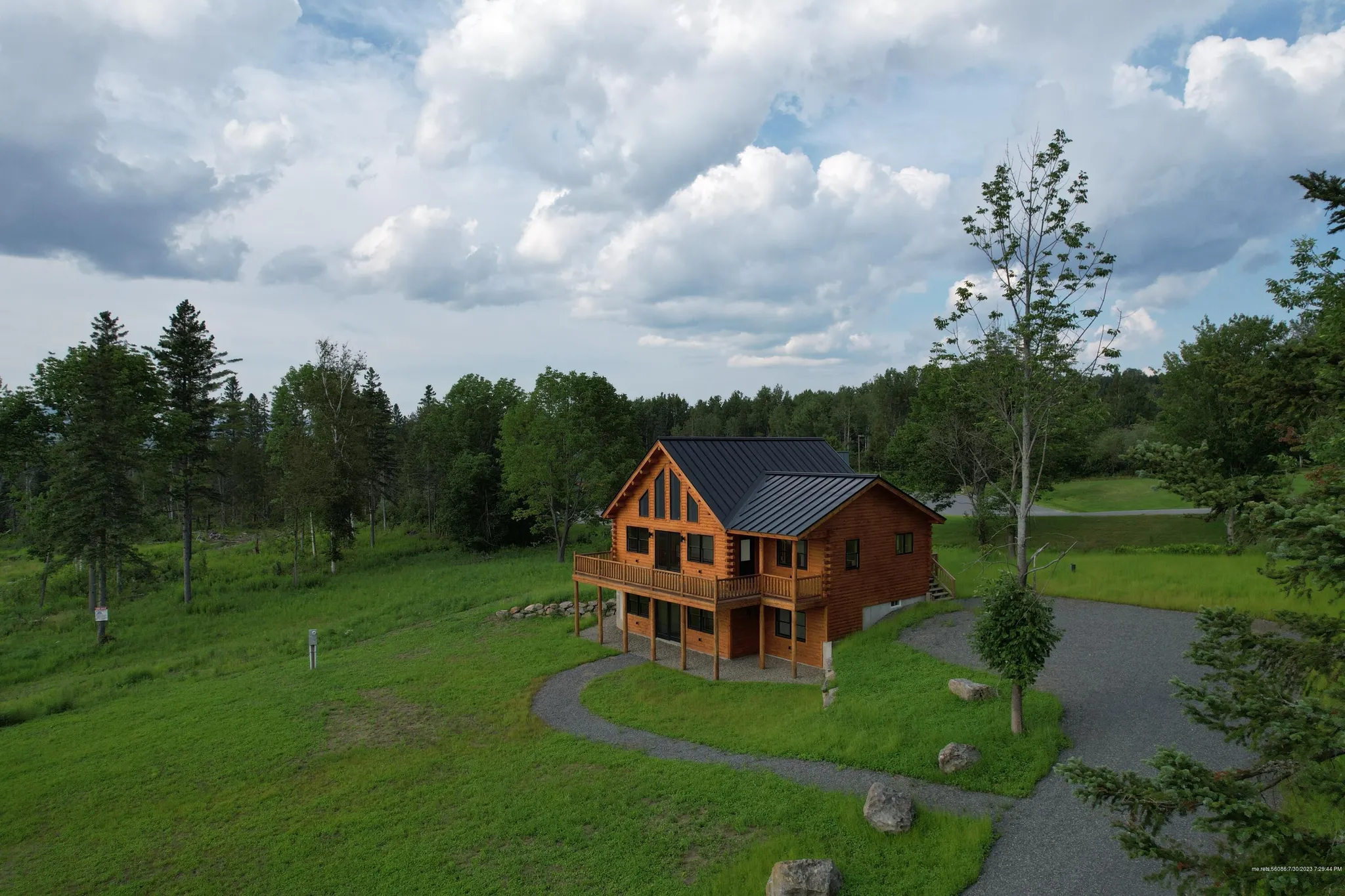 large log home exterior with deck