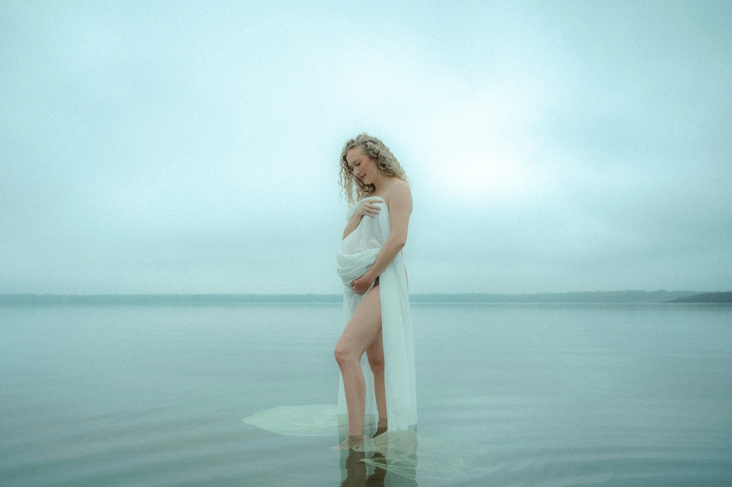 creative maternity photoshoot standing in water
