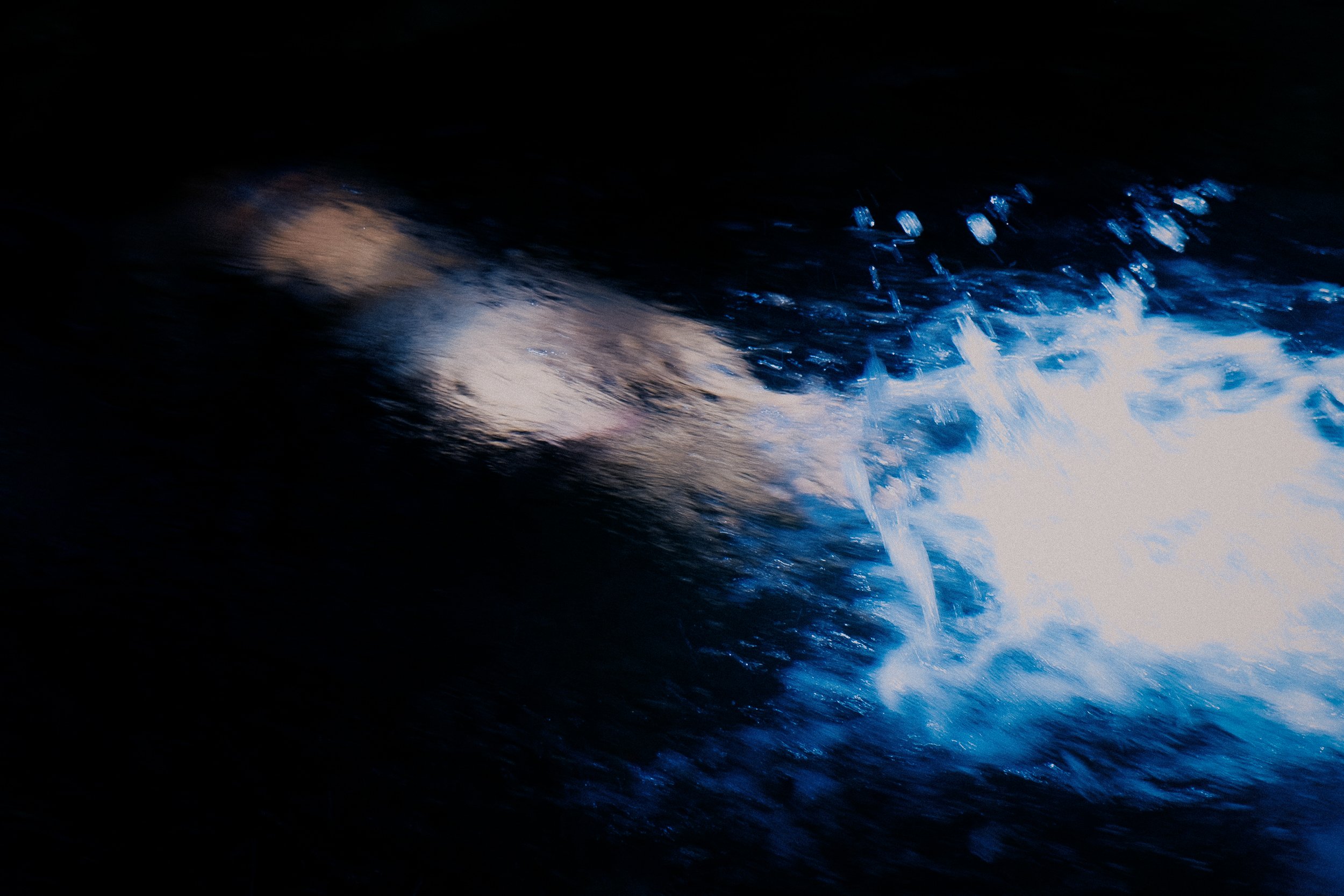 Blurred motion of bright light on dark background