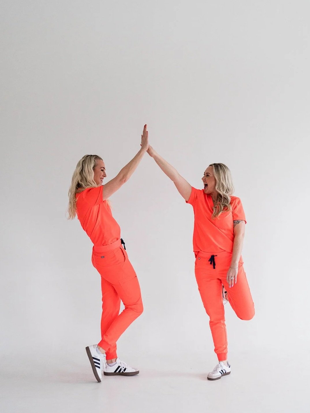 A Younger You Aesthetics nurse practitioners high fiving