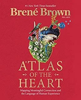 Book cover of "Atlas of the Heart" by Brene Brown, featuring an outline of the United States filled with flowers, birds, and various images, all set against a red background.