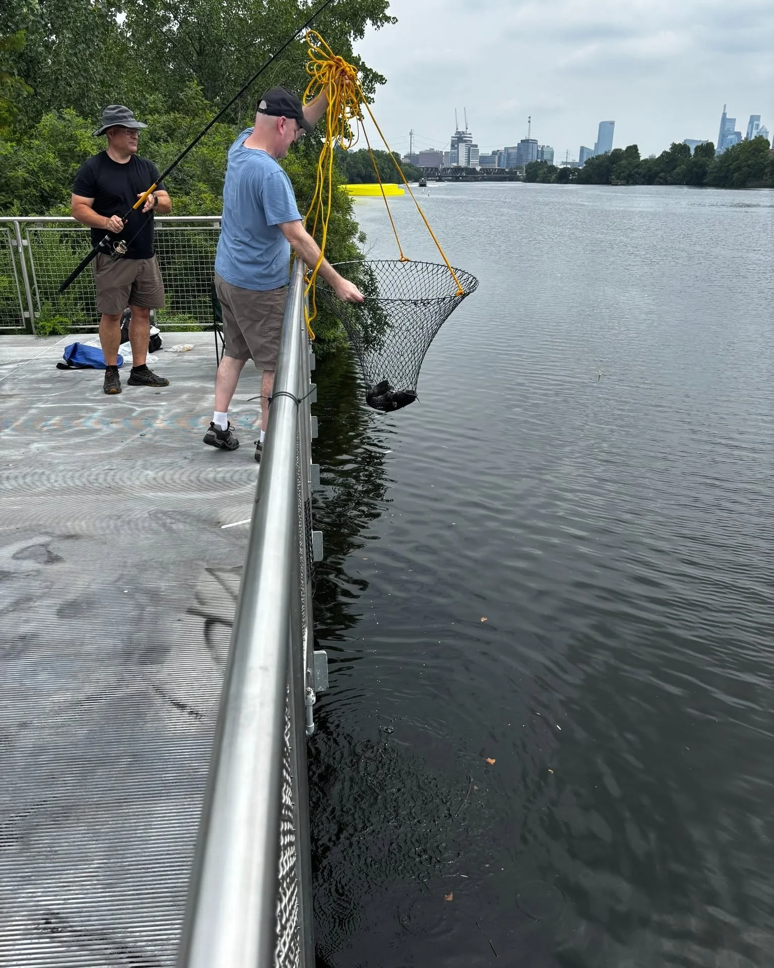 Men are pulling up a fish out of the water
