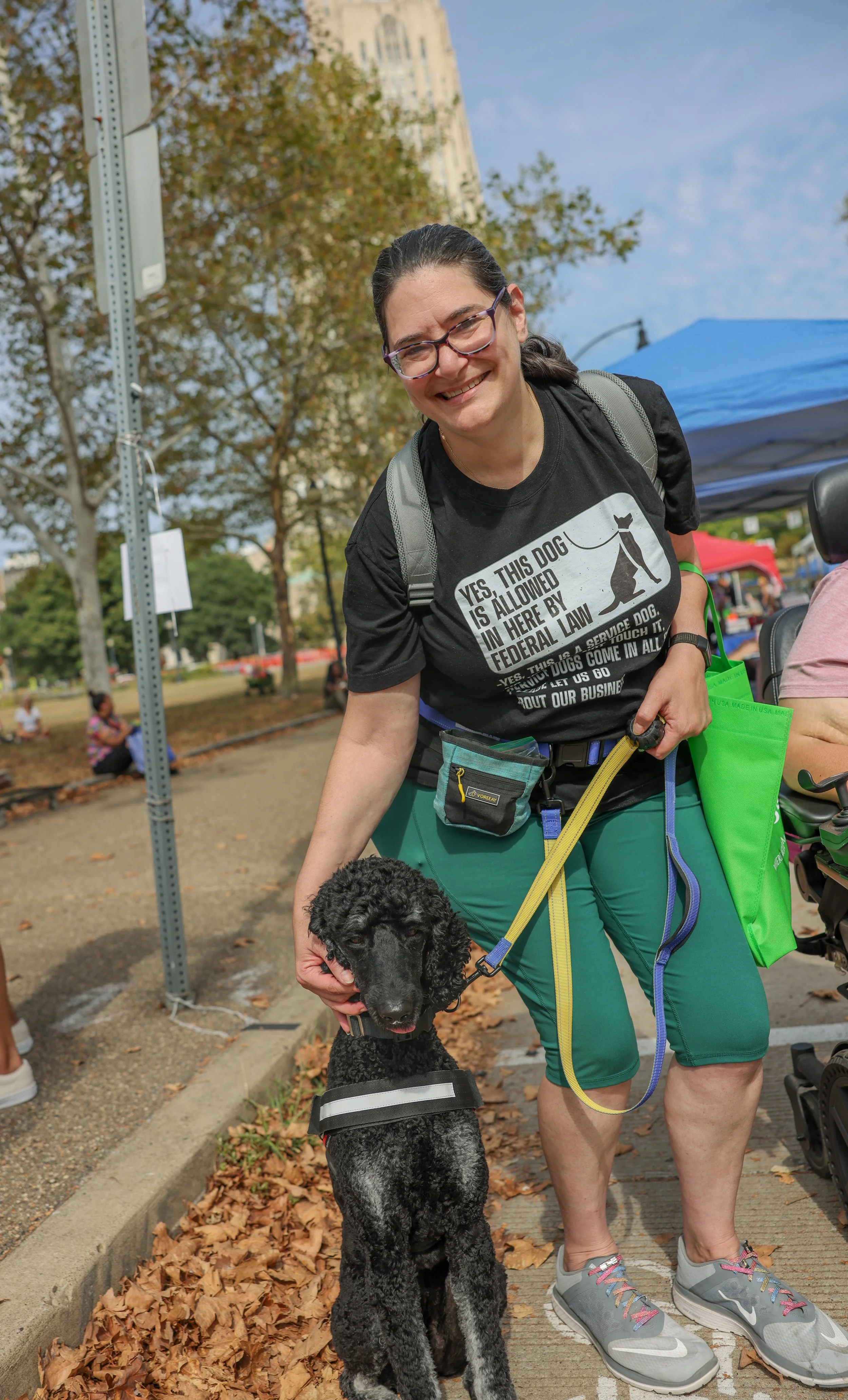 Woman with black service dog wearing shirt: "Yes, this dog is allowed here by federal law"
