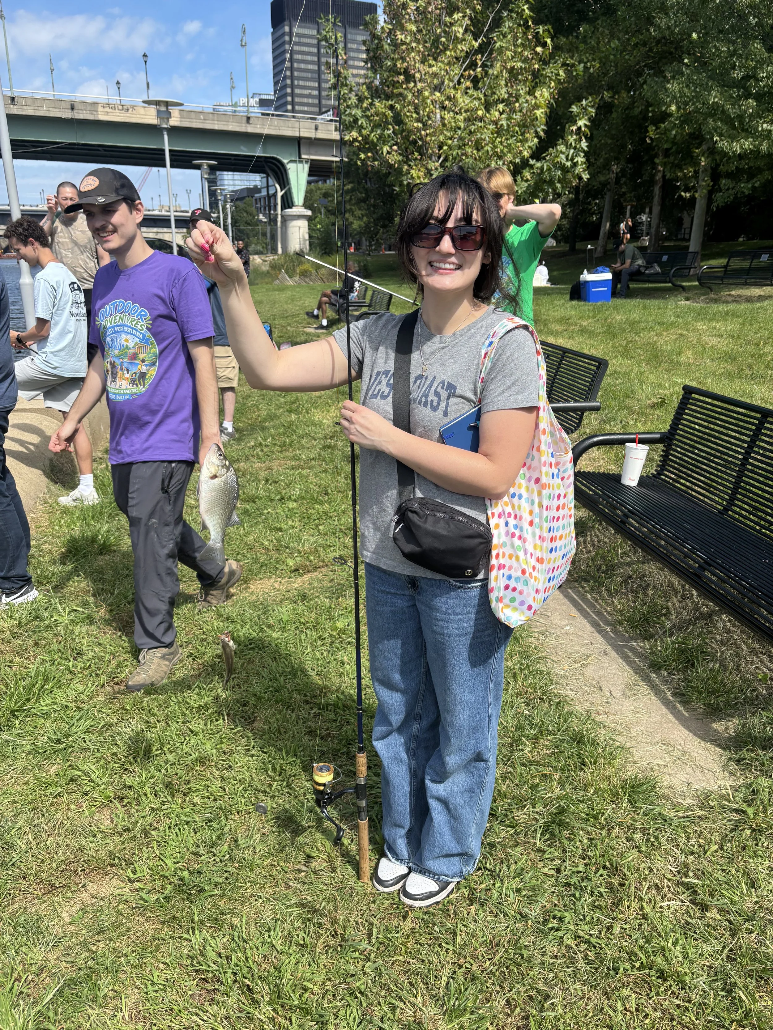 A person holds up the fish they caught.