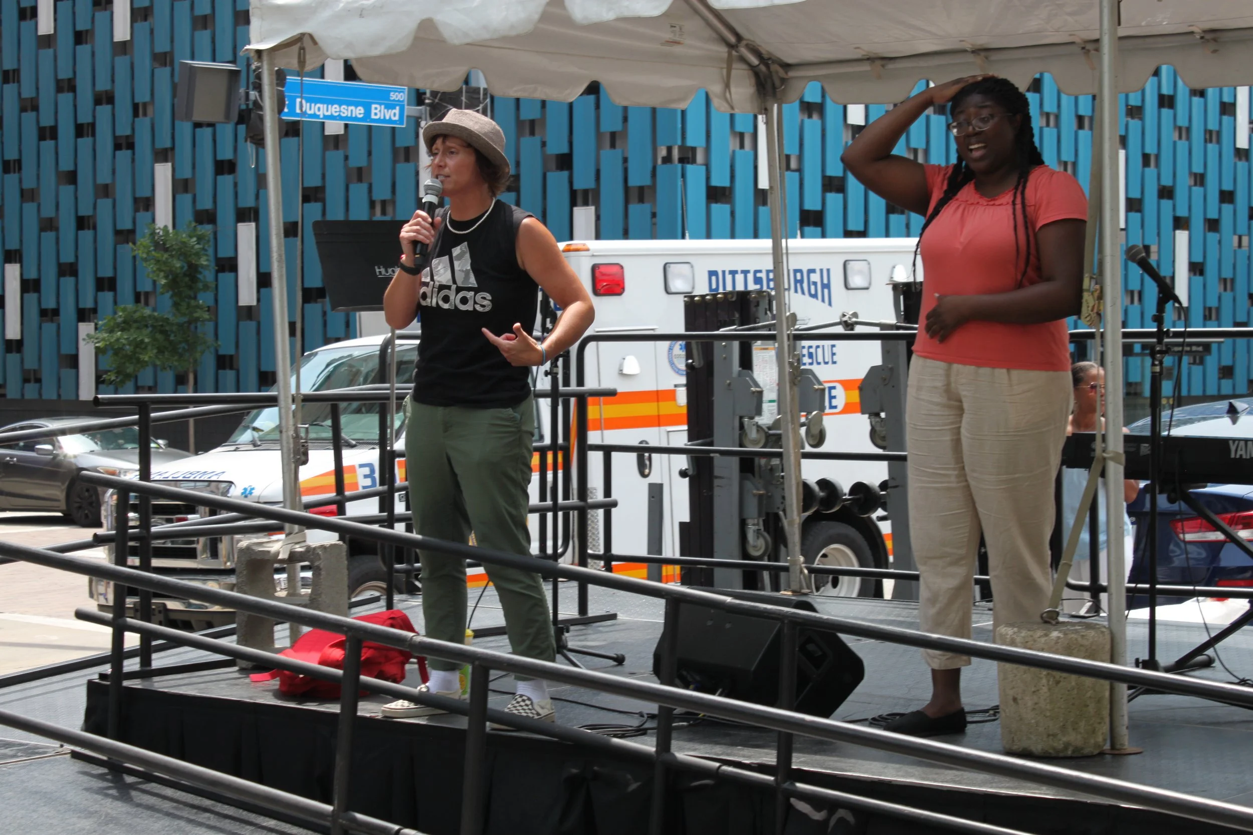 Gab Bonesso on a stage with ramp coming up the front with ASL interpreter in Pittsburgh
