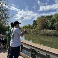 Two people fishing together with a lake view