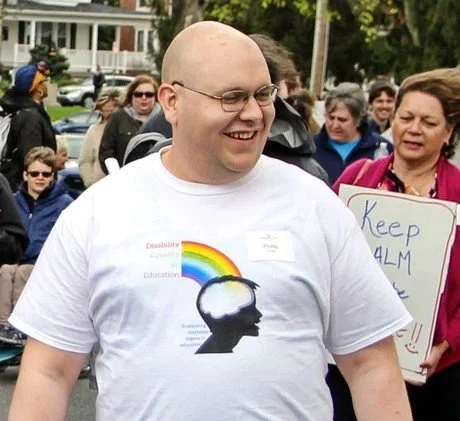 Smiling man walking in a parade.