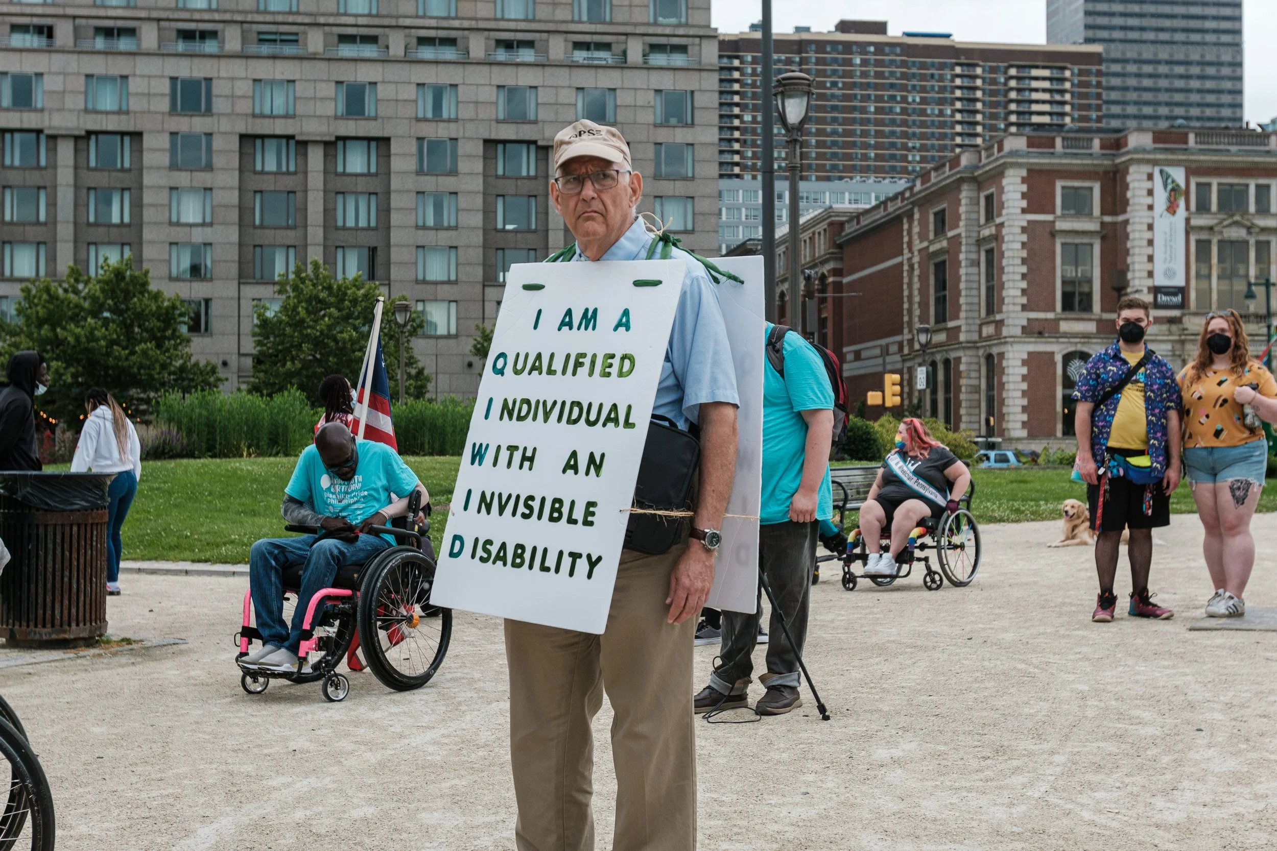 Rich wearing his sign on front and back with parade goers in background