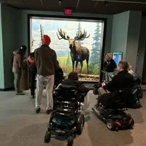 People checking out an exhibit of a Moose at the Academy of Natural Sciences