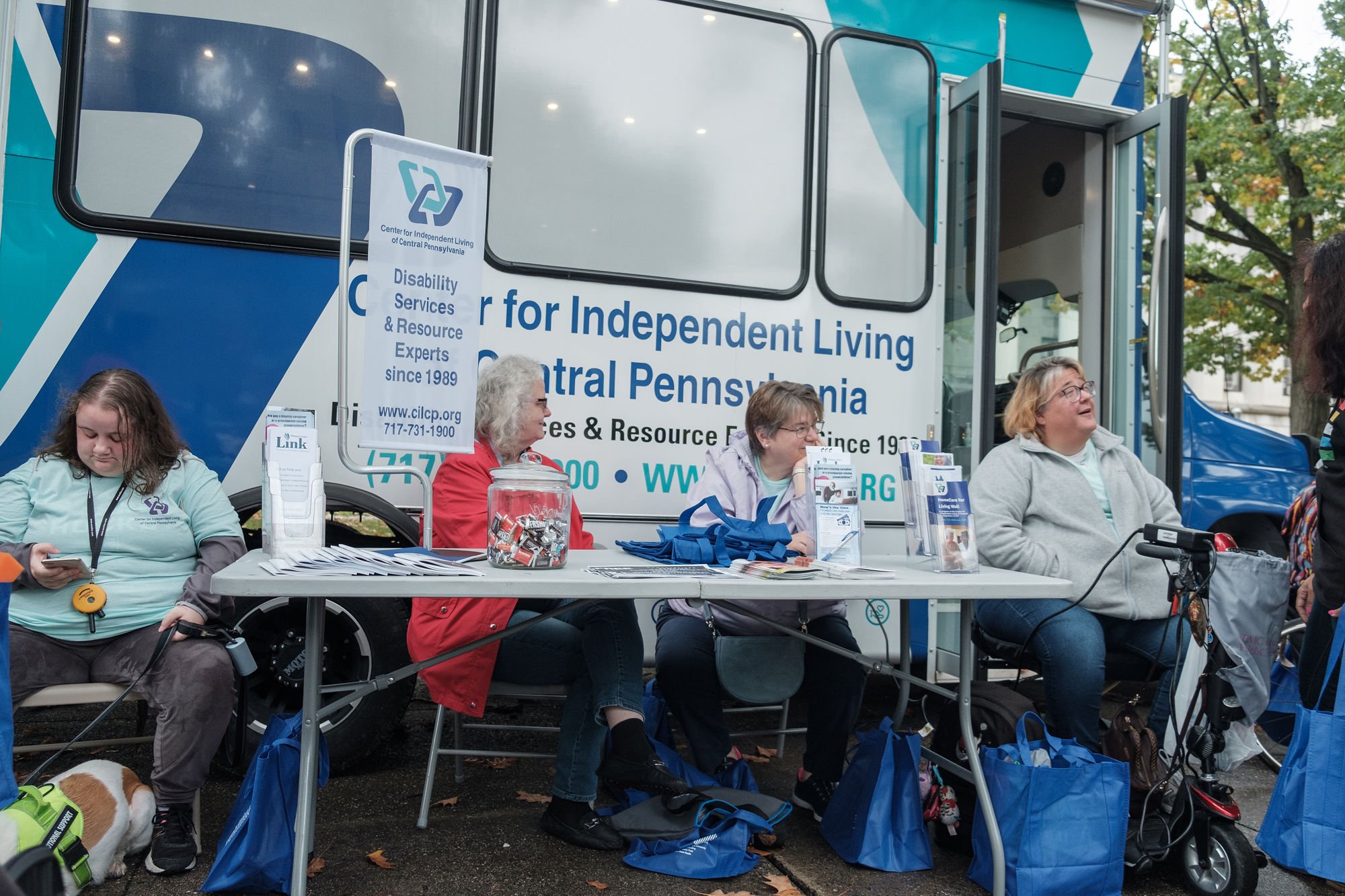 Center for Independent Living of Central PA folx sitting around their table in front of their bus