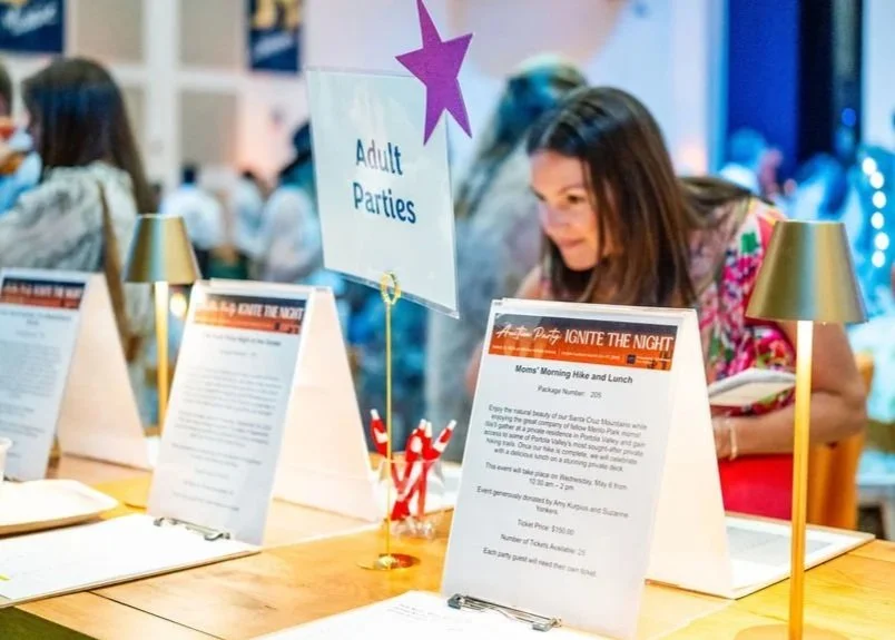 Image of silent auction bid tables at 2026 Auction Party