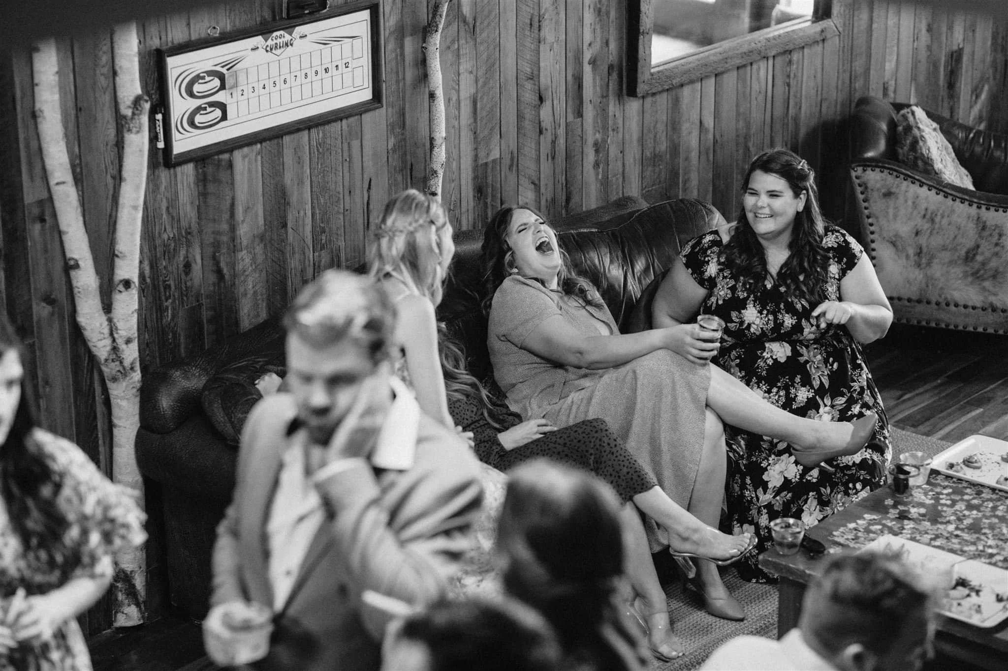 Friends laughing downstairs during cocktail hour at Serenity Cottage wedding