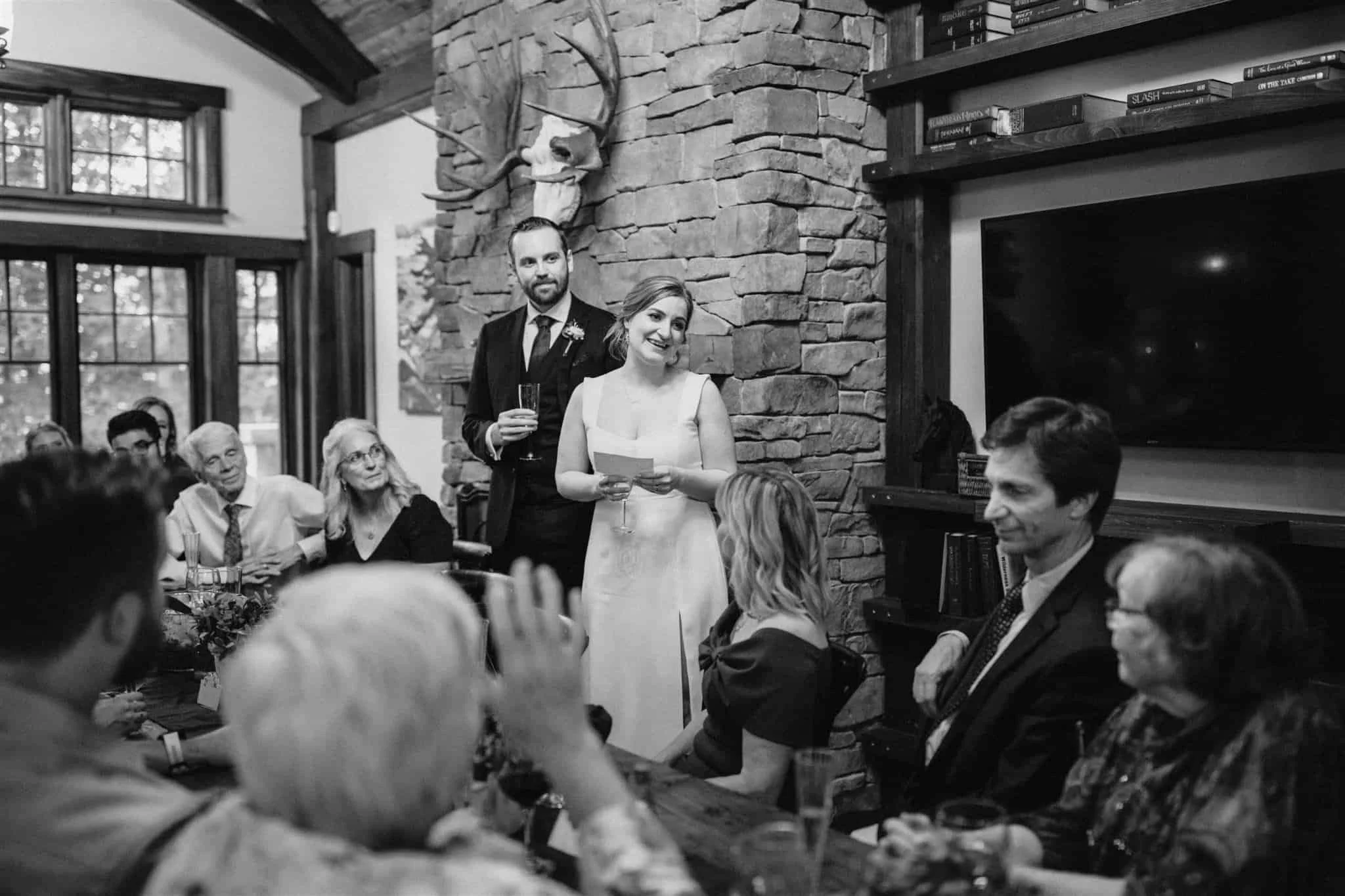 Bride gives toast at intimate wedding dinner at Serenity Cottage