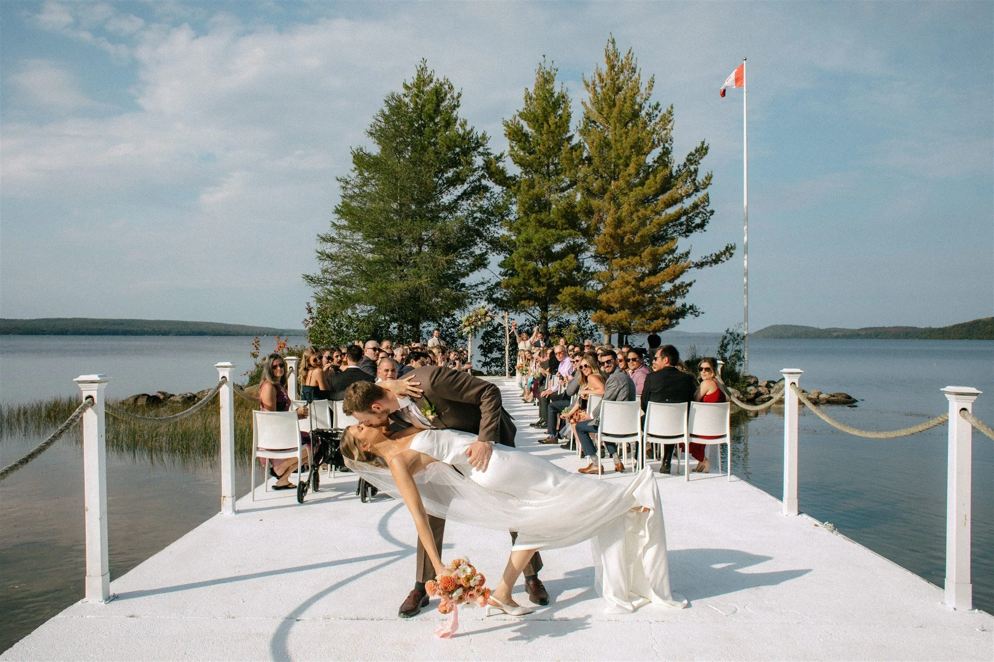 Couple sharing a dip and kiss at the end of their Northridge Inn wedding ceremony