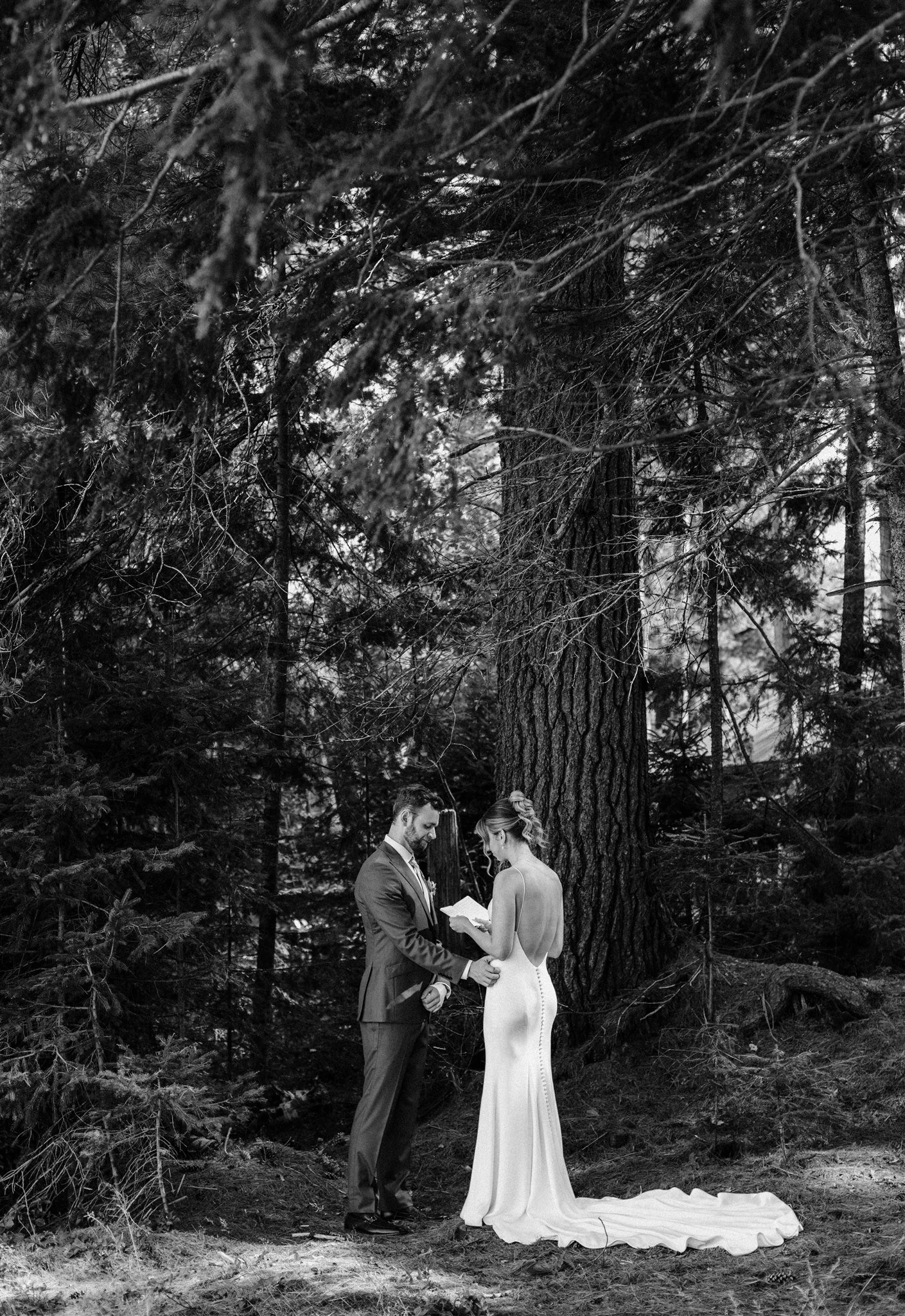 Couple sharing private vows in the tall pines at Northridge Inn