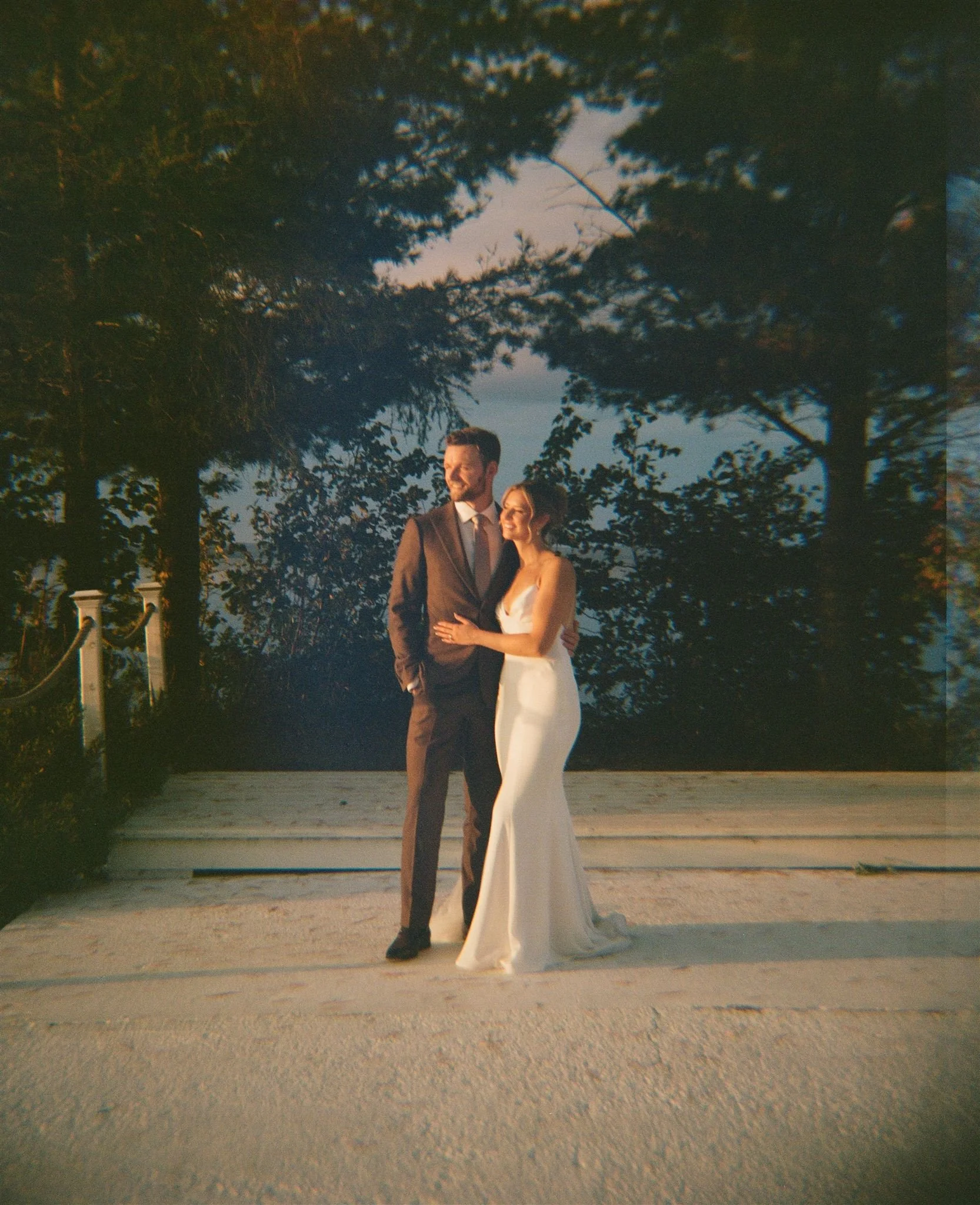 Couple portraits among tall pines at Northridge Inn wedding in Sundridge Ontario shot on film