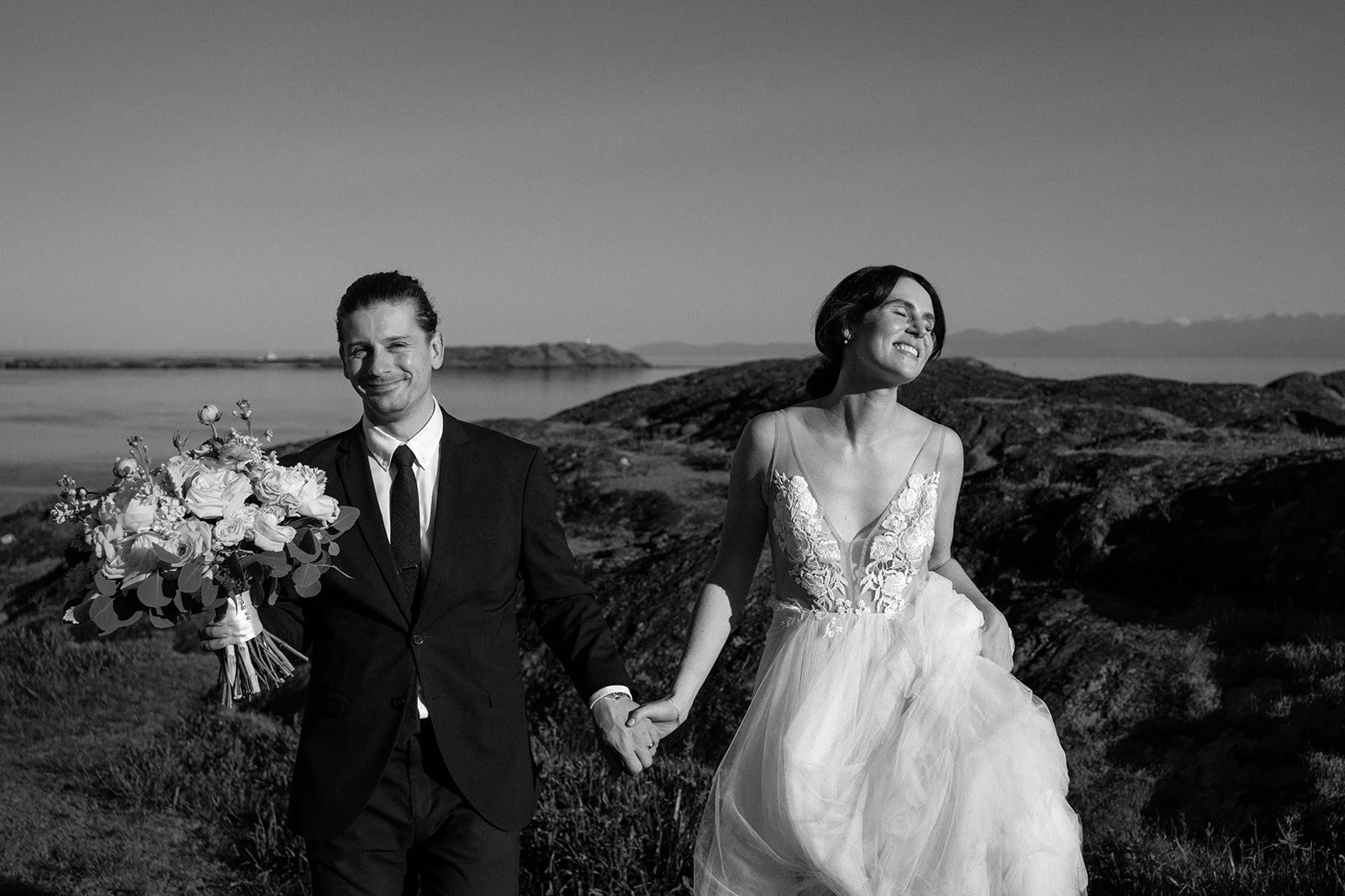 candid wedding moment with groom holding bouquet