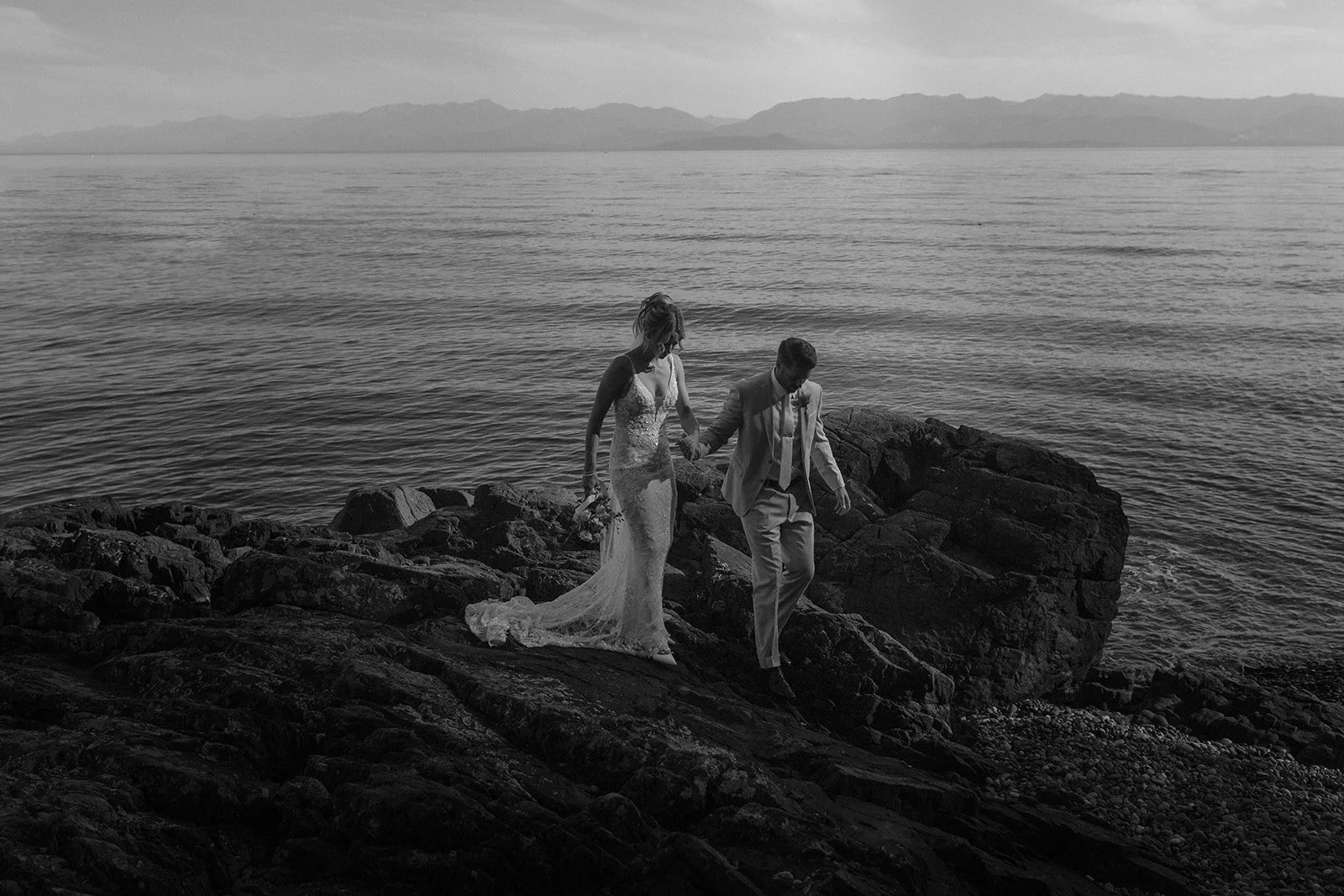 bride and groom portrait walking on the beach at Oak Bay Beach Hotel venue