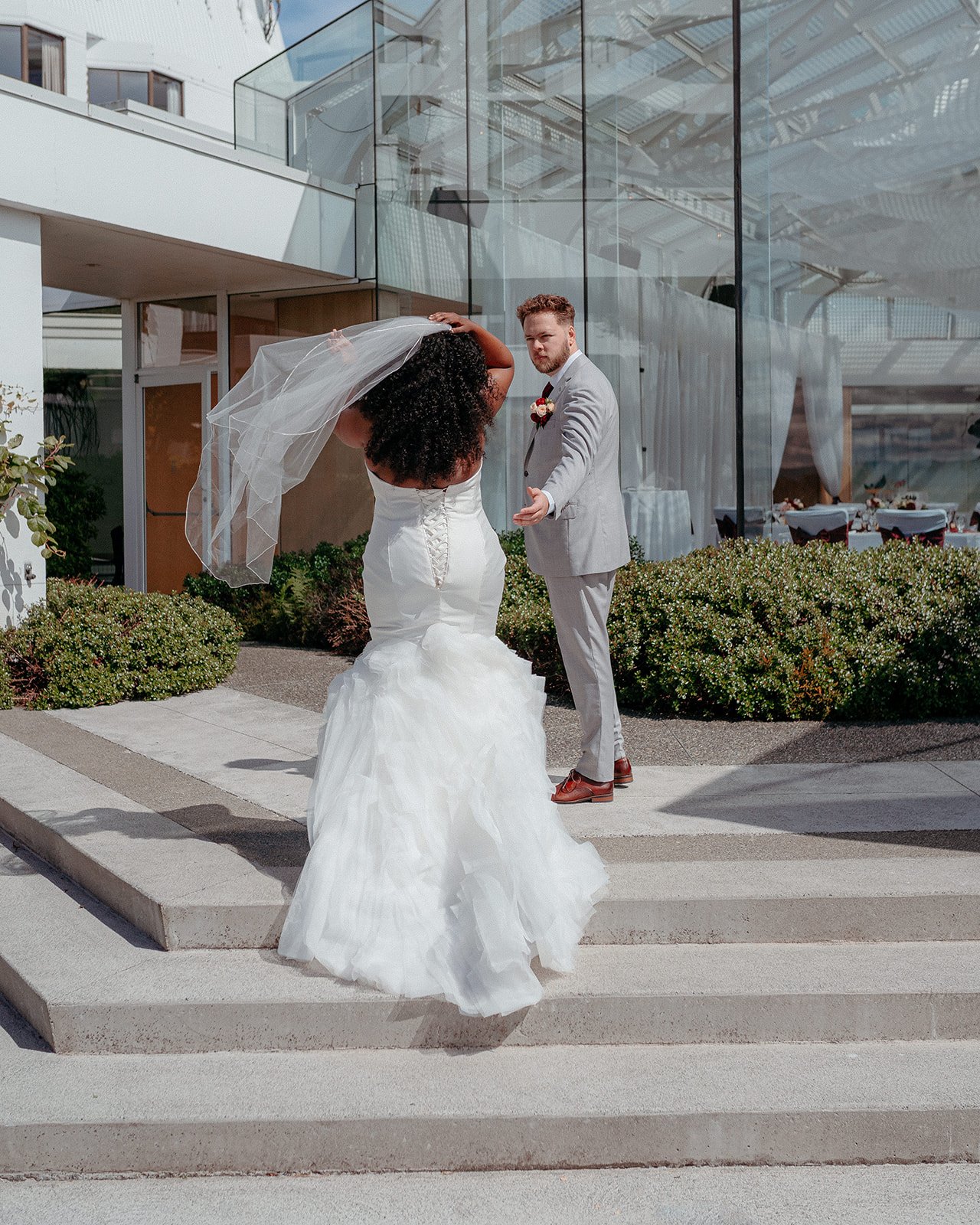 bride and groom outside Laurel Point wedding venue in Victoria BC