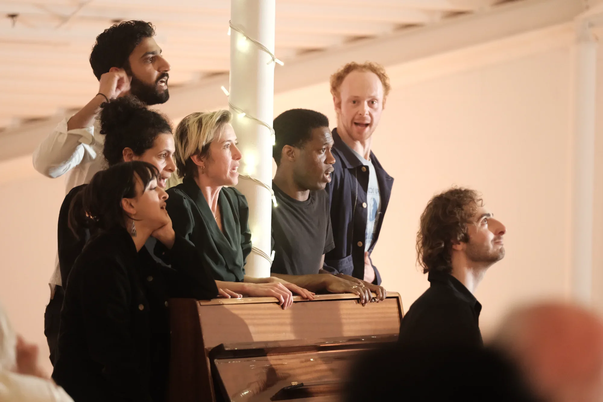 The SCRUM Company, singing, clutching a piano, at various levels of excitement