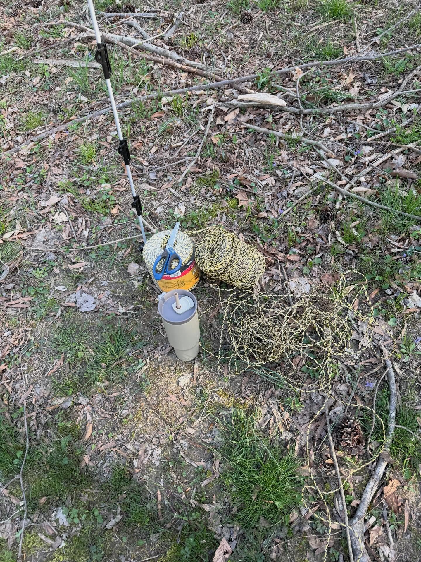 My husband&rsquo;s version of helping me string fence. Water, scissors, and polywire. Aka here are your tools, good luck.