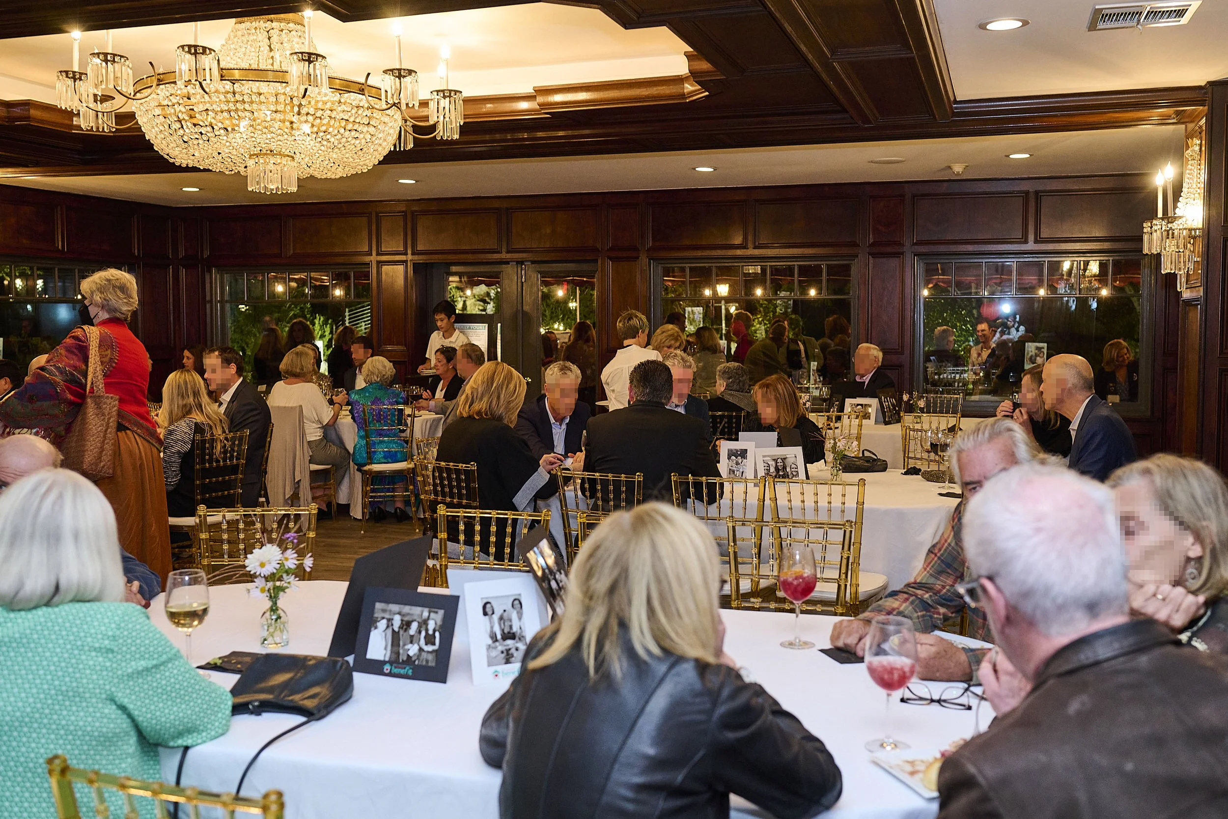 Tranquil celebration of life gathering in a private, wood-paneled event room.