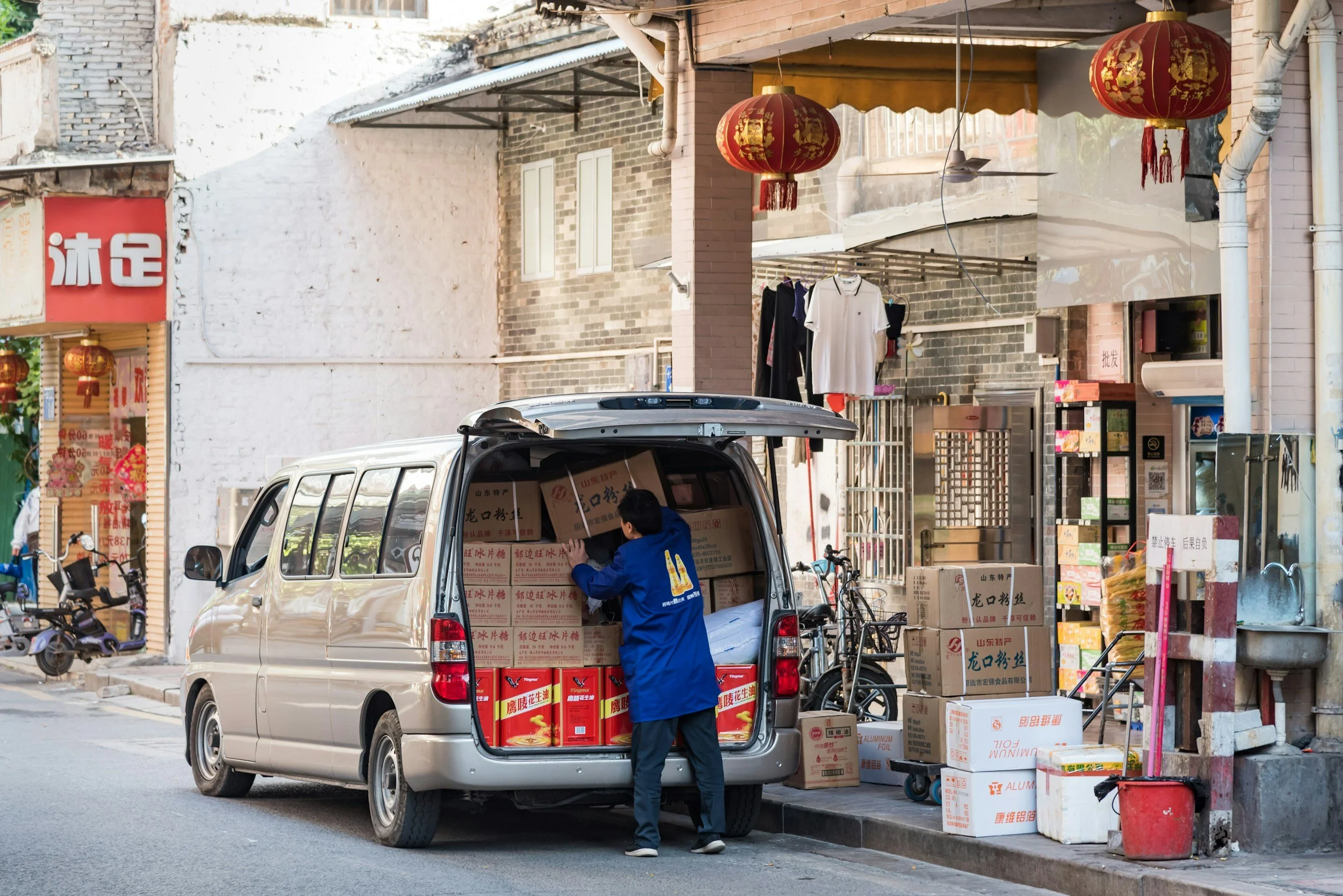 Commercial cargo van being loaded for a local delivery.