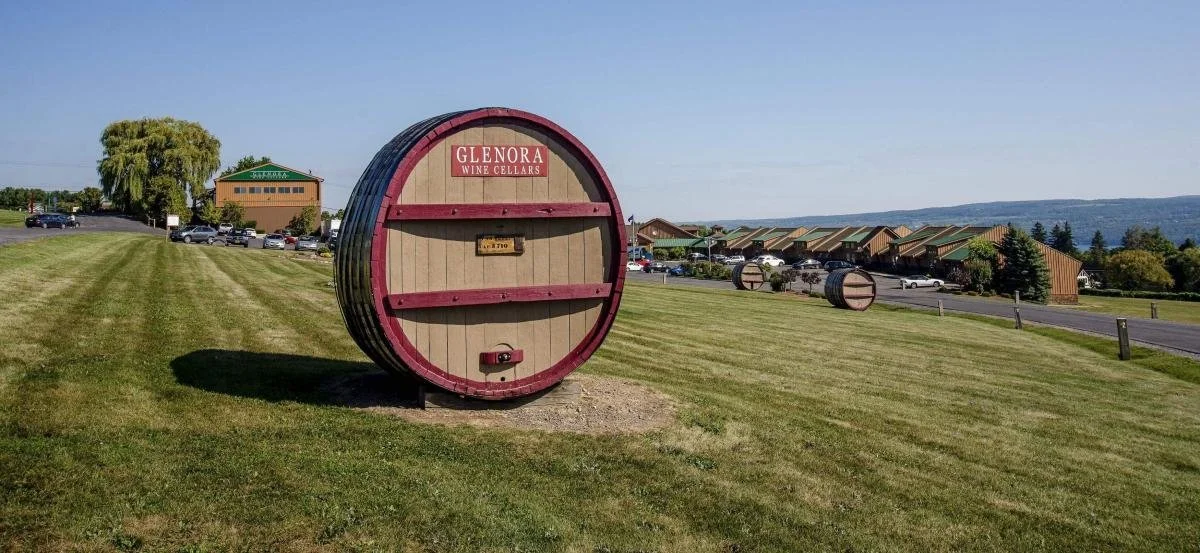a large wooden wine barrel showing Glenora Wine cellars