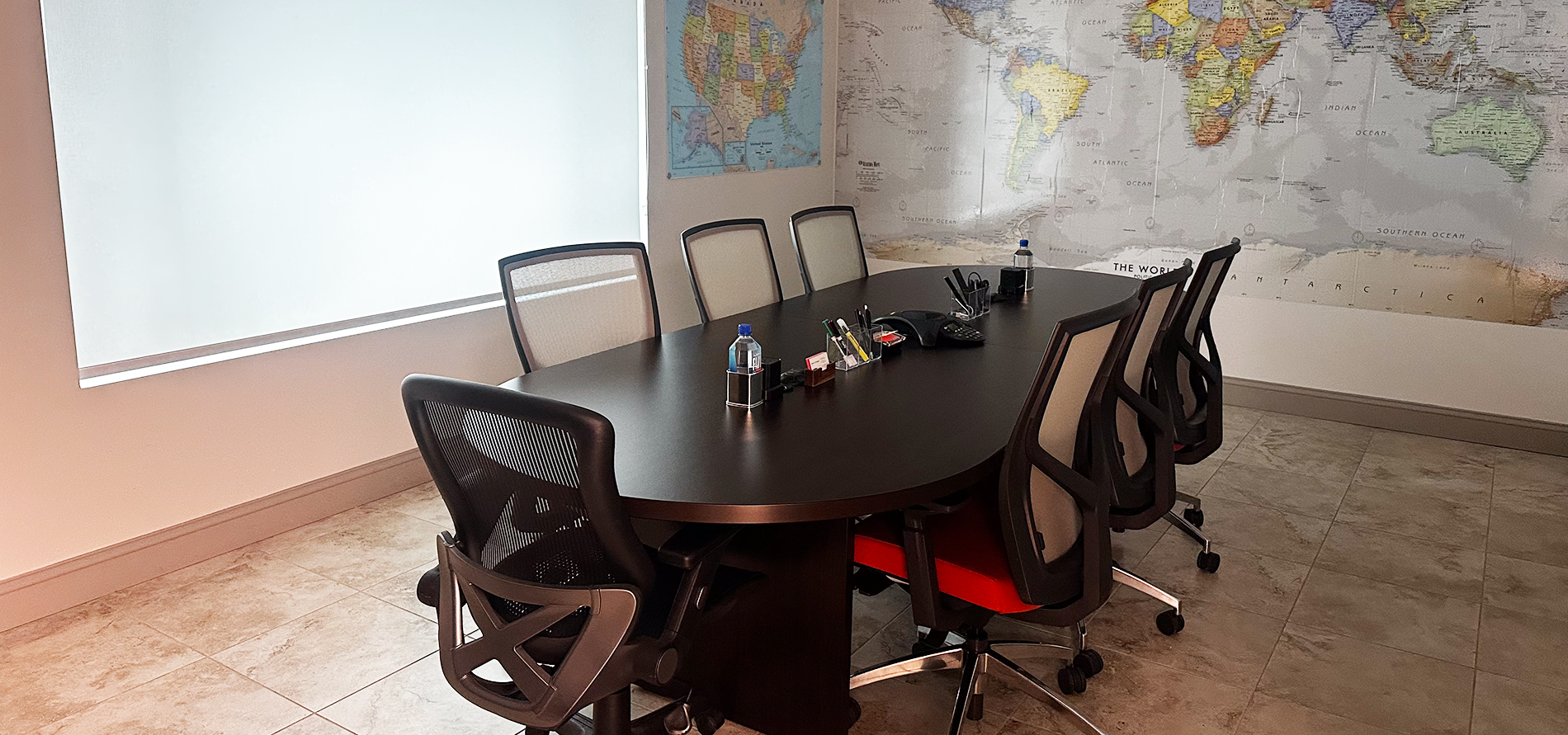 Various logistics containers and trailers parked outdoors under a clear blue sky, with trees in the background.