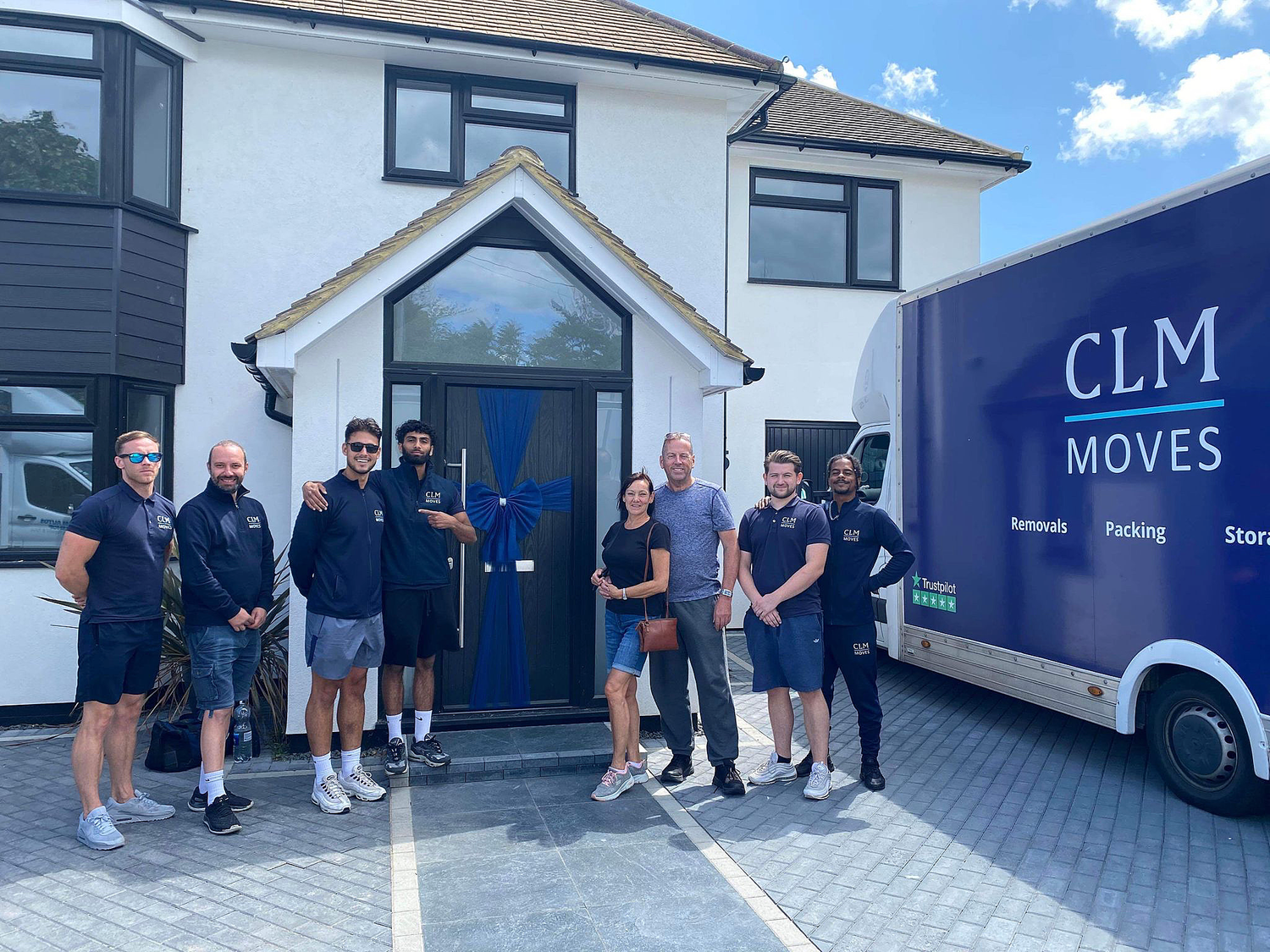 The CLM Moves team outside a client property
