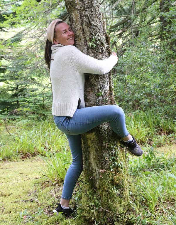 A woman hugging a tree