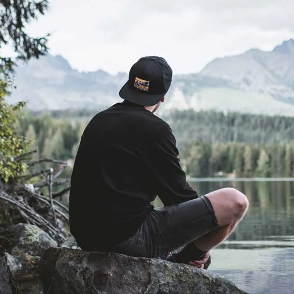 Young Man Sitting By  A Lake