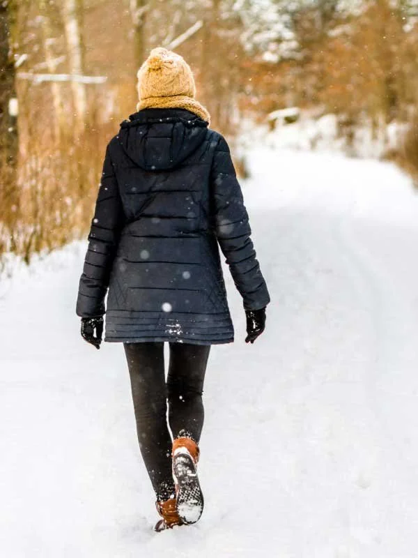 A young woman walking in winter