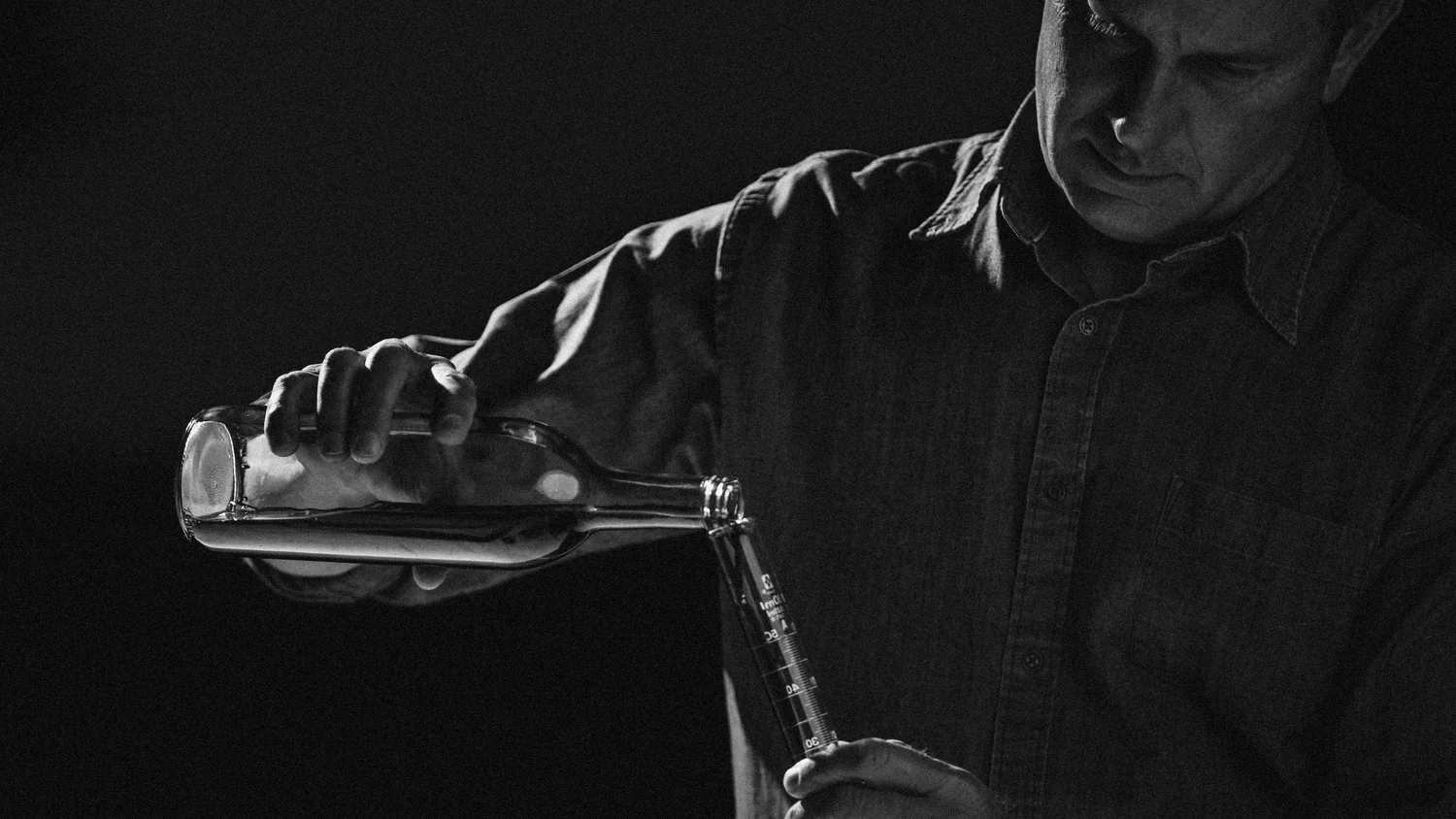 Winemaker pouring a sample in the laboratory