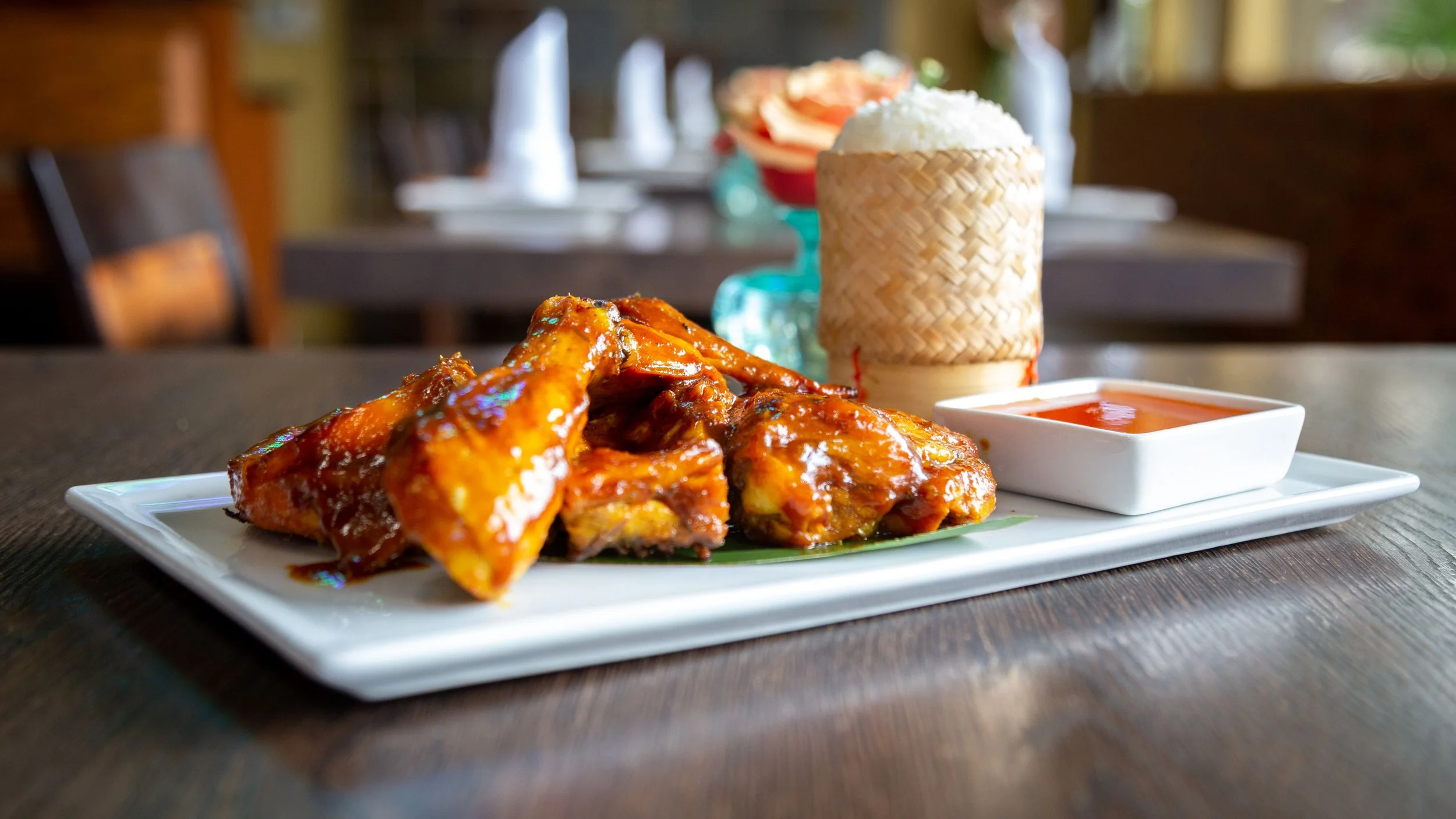 Thai BBQ Chicken with homemade sticky rice served with sweet and sour sauce.