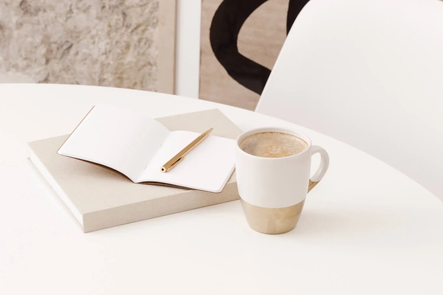 opened notebook next to a cup of coffee