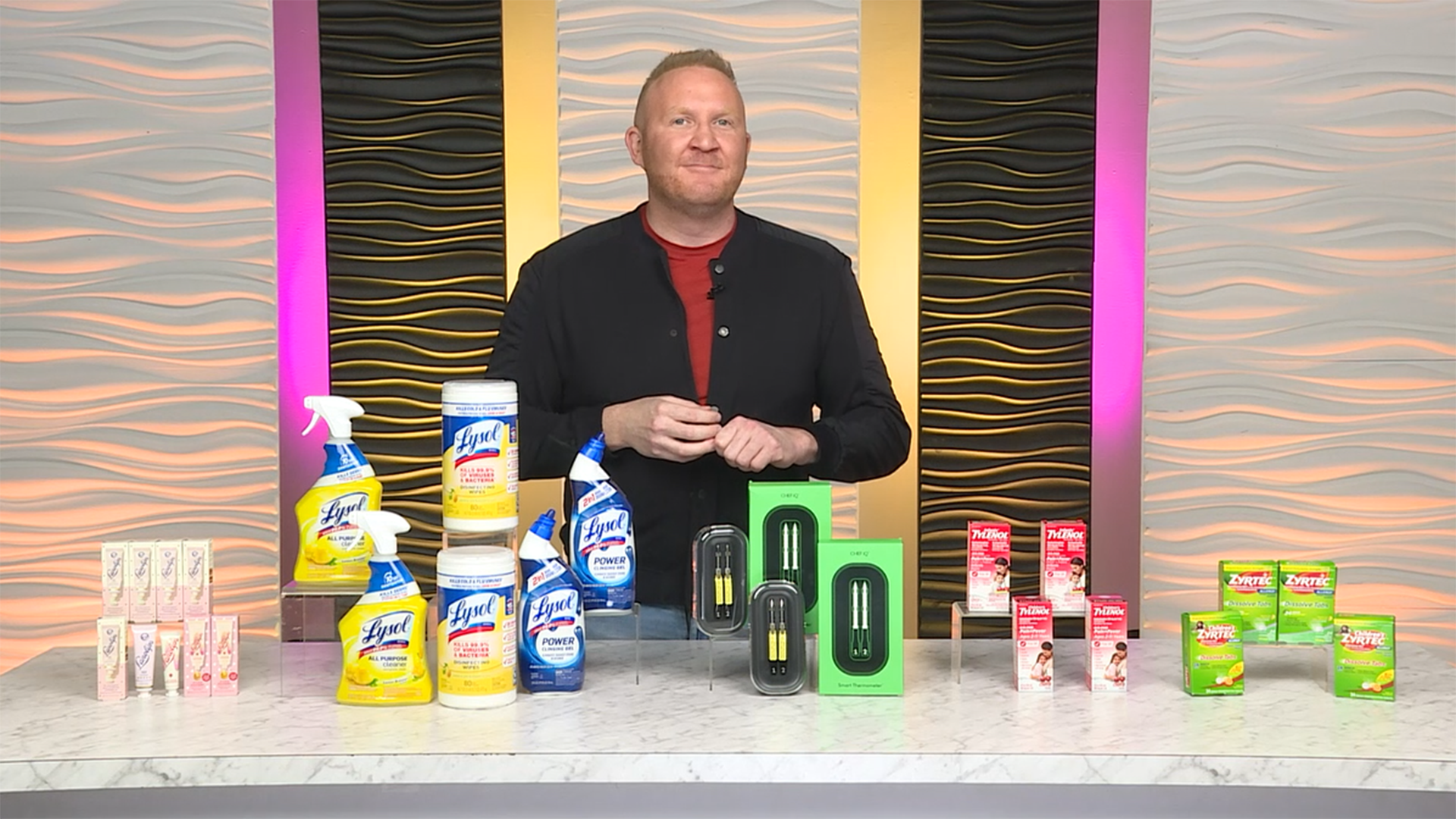 Man standing behind a table with various products