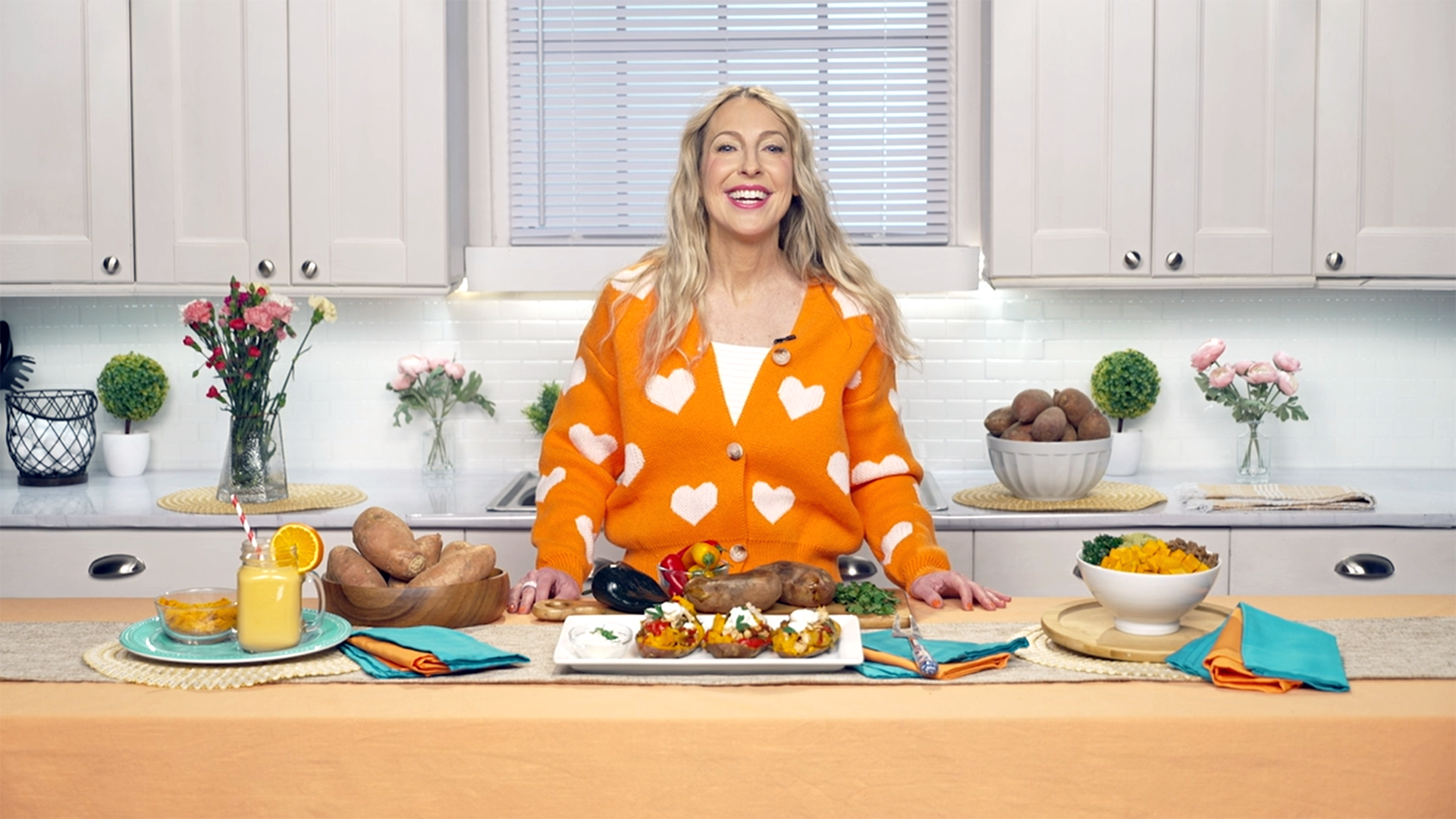 Woman in orange sweater in kitchen