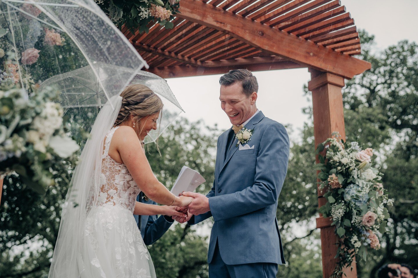 Yesterdays drizzly weather had me thinking about this sweet wedding. We can't control the weather but this couple still had the most joyful event.

How beautiful is this arbor made by one of the Fathers? I just love adding florals to a structure made