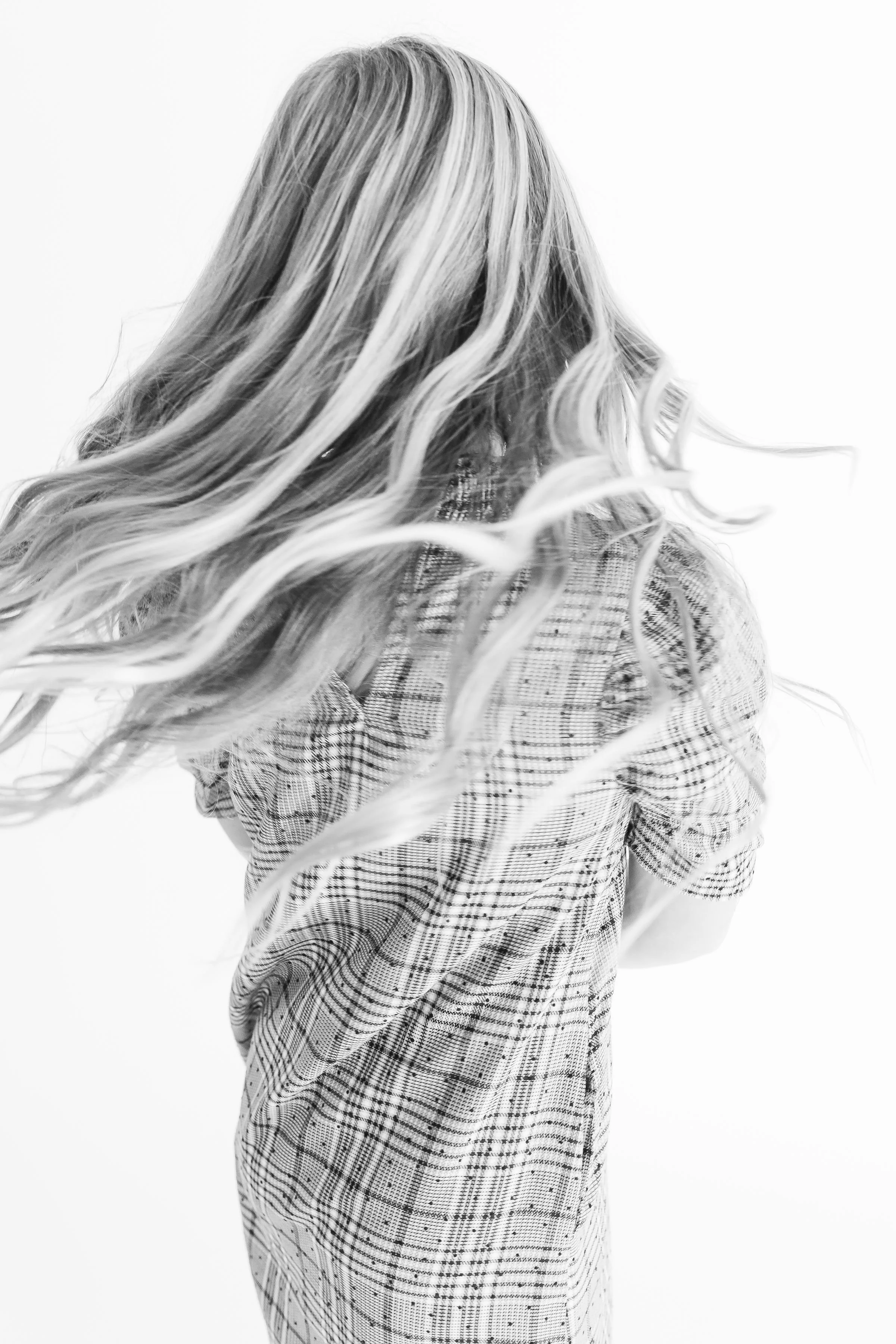 Black and white personality portrait of a girl spinning during a fun photography session in Tulsa, OK.