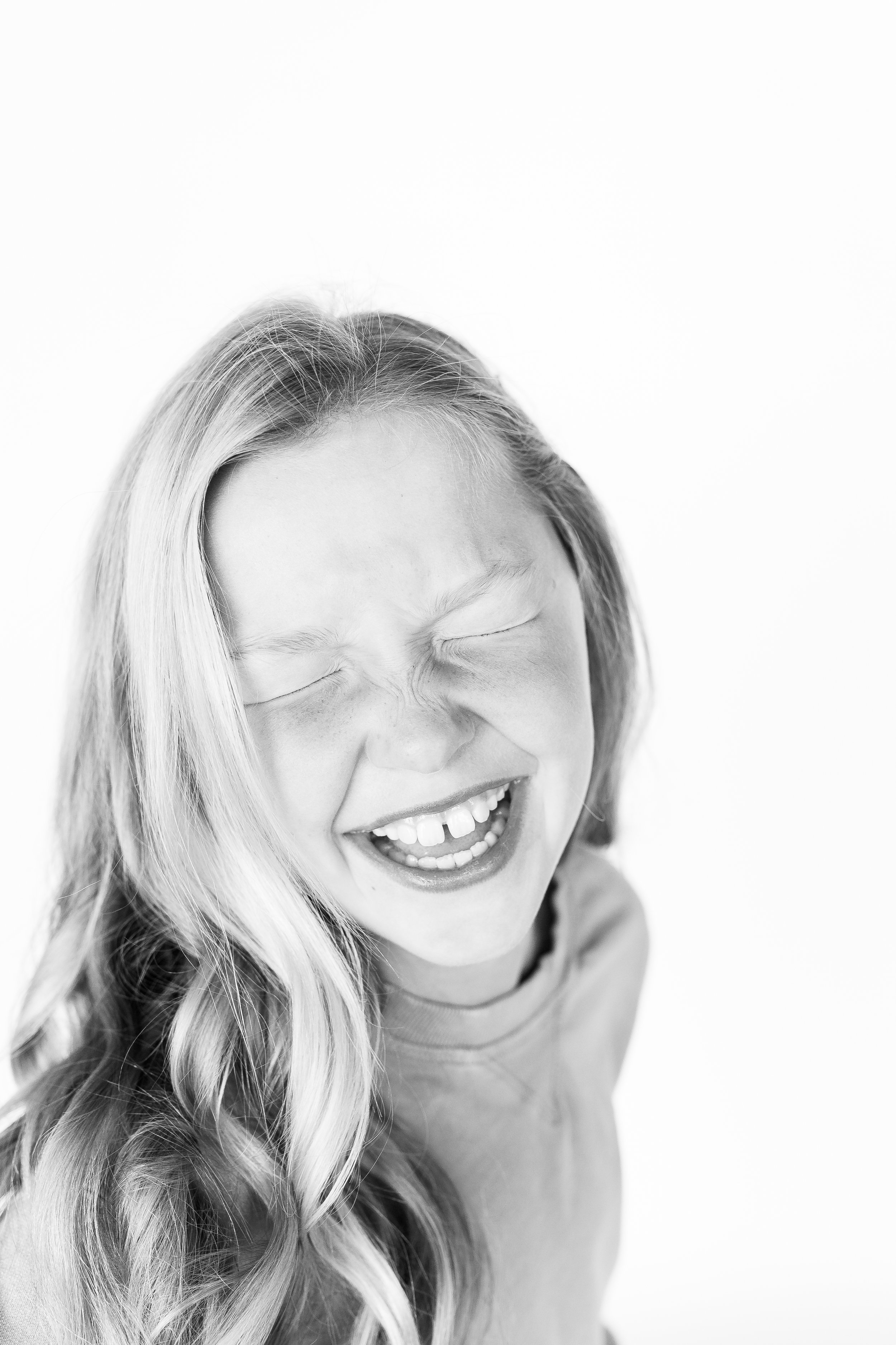 Joyful childhood portraiture in heirloom black and white style. Tulsa based studio photography by Kacey Gilpin.