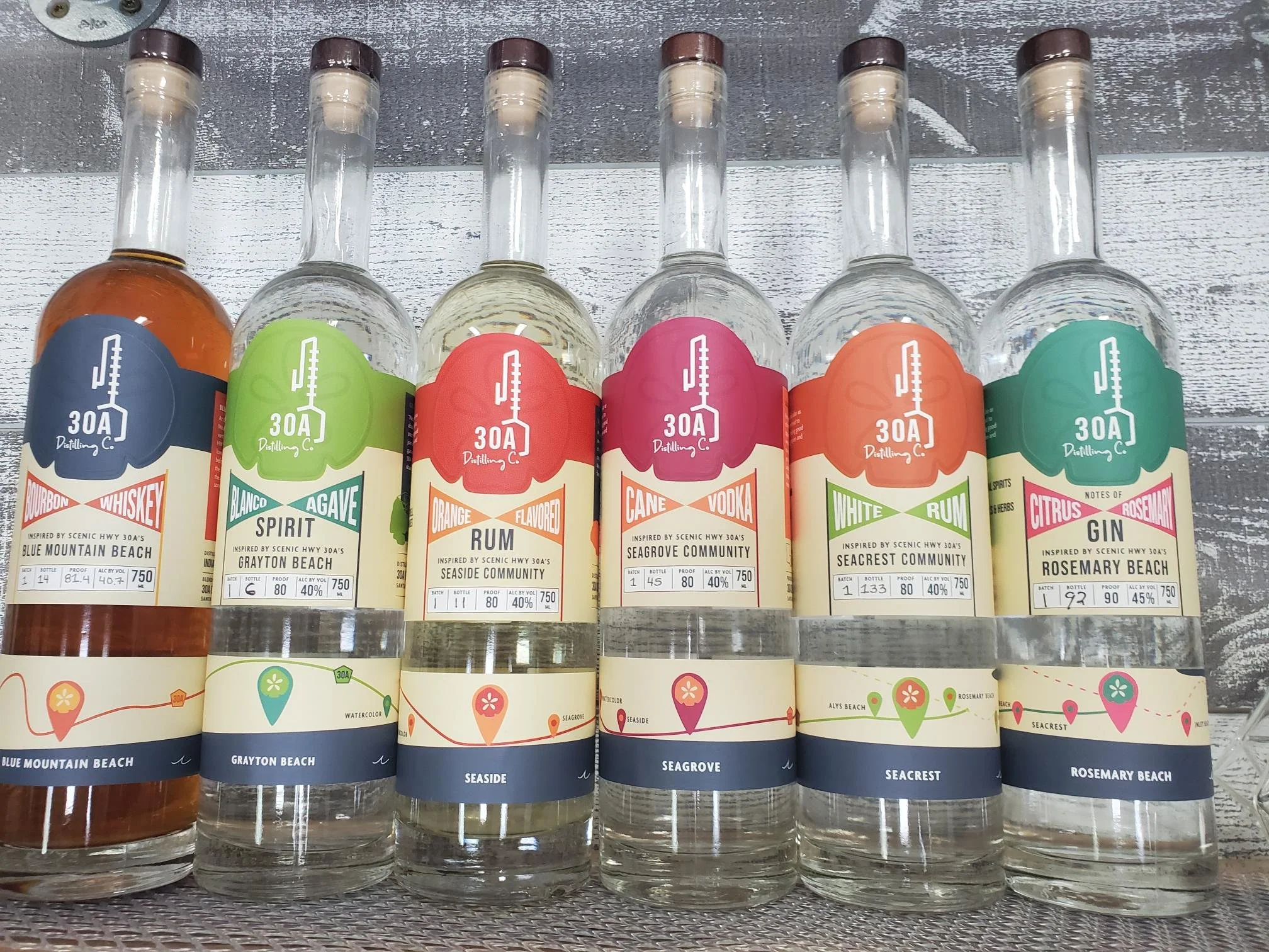 30A Distilling Co. craft spirits lineup featuring bourbon whiskey, blanco agave spirit, orange flavored rum, cane vodka, white rum, and citrus rosemary gin inspired by Scenic Highway 30A beach communities.