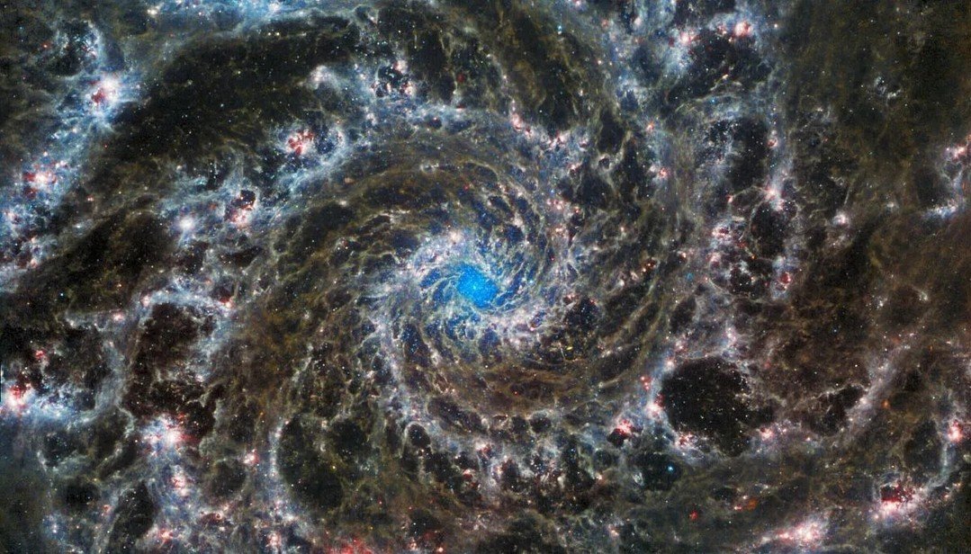 Spirals cast in night,
phantom's gleam in vast expanse&mdash;
whispers of starlight.

#JWST #NASA #M74 #Phantom #Galaxy #Poem